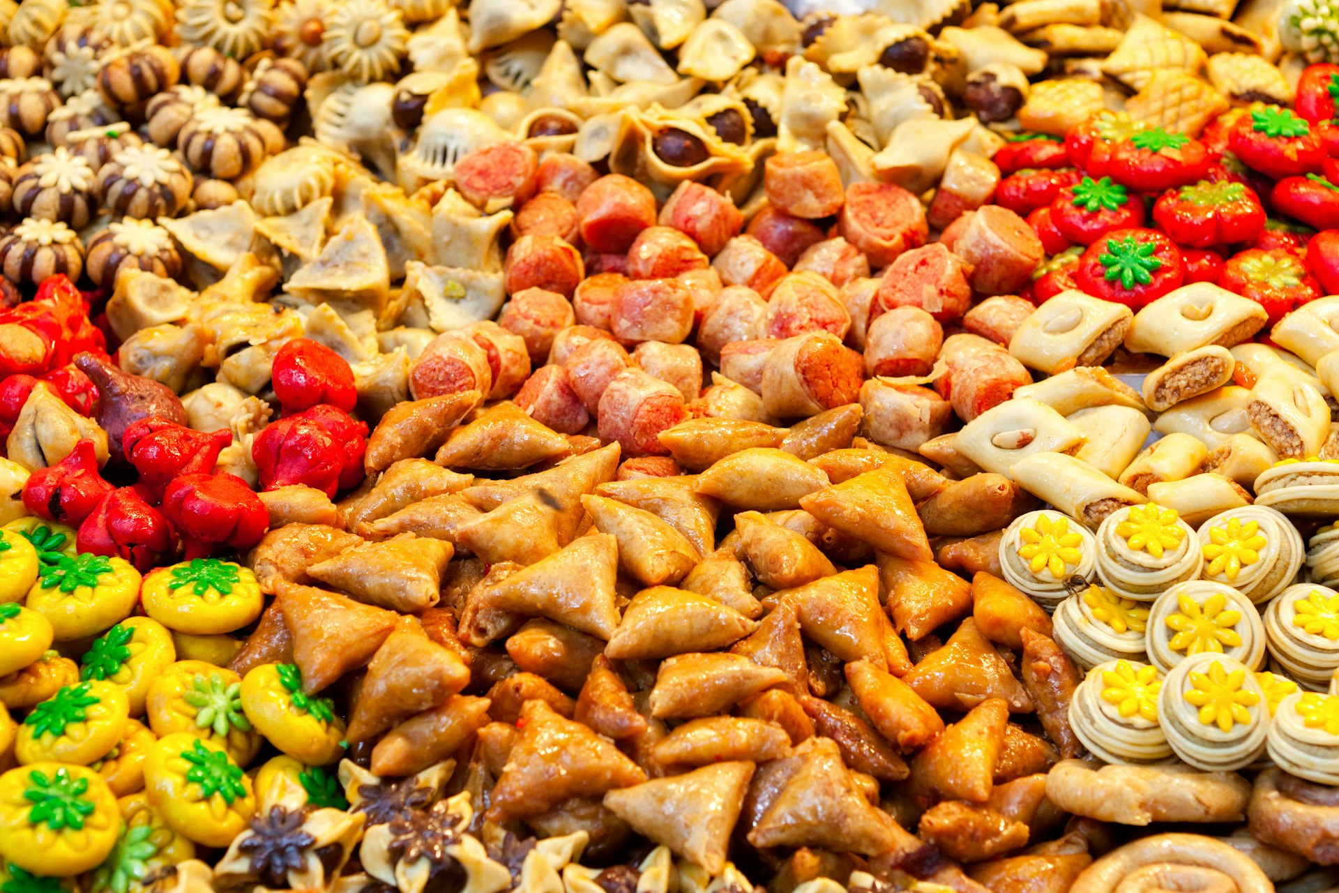 Closeup of a stall filled with traditional moroccan sweets on sale at a Marrakesh market