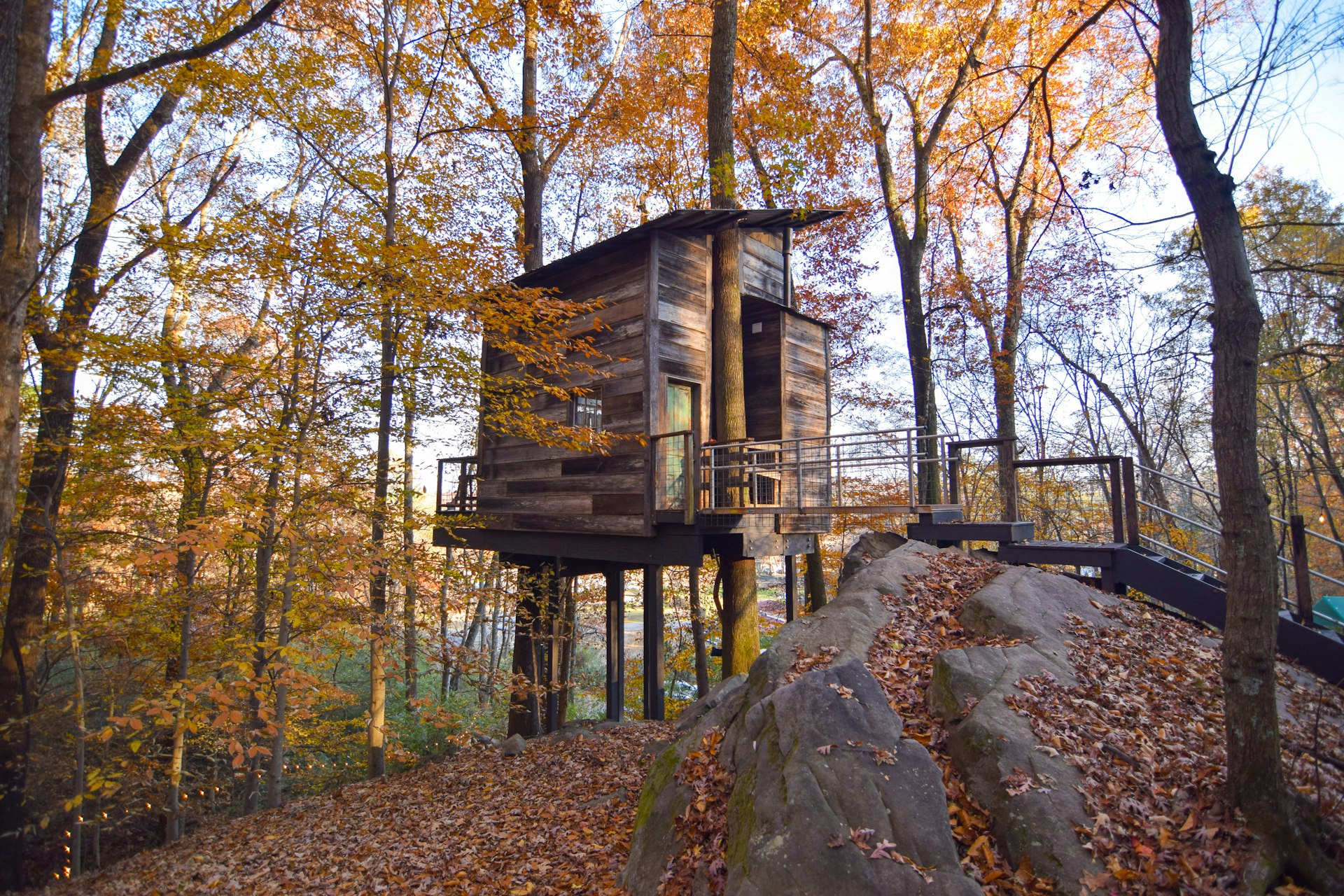 Tree house at Treetop Hideaways surrounded by trees and fall leaves in Chattanooga, Tennessee