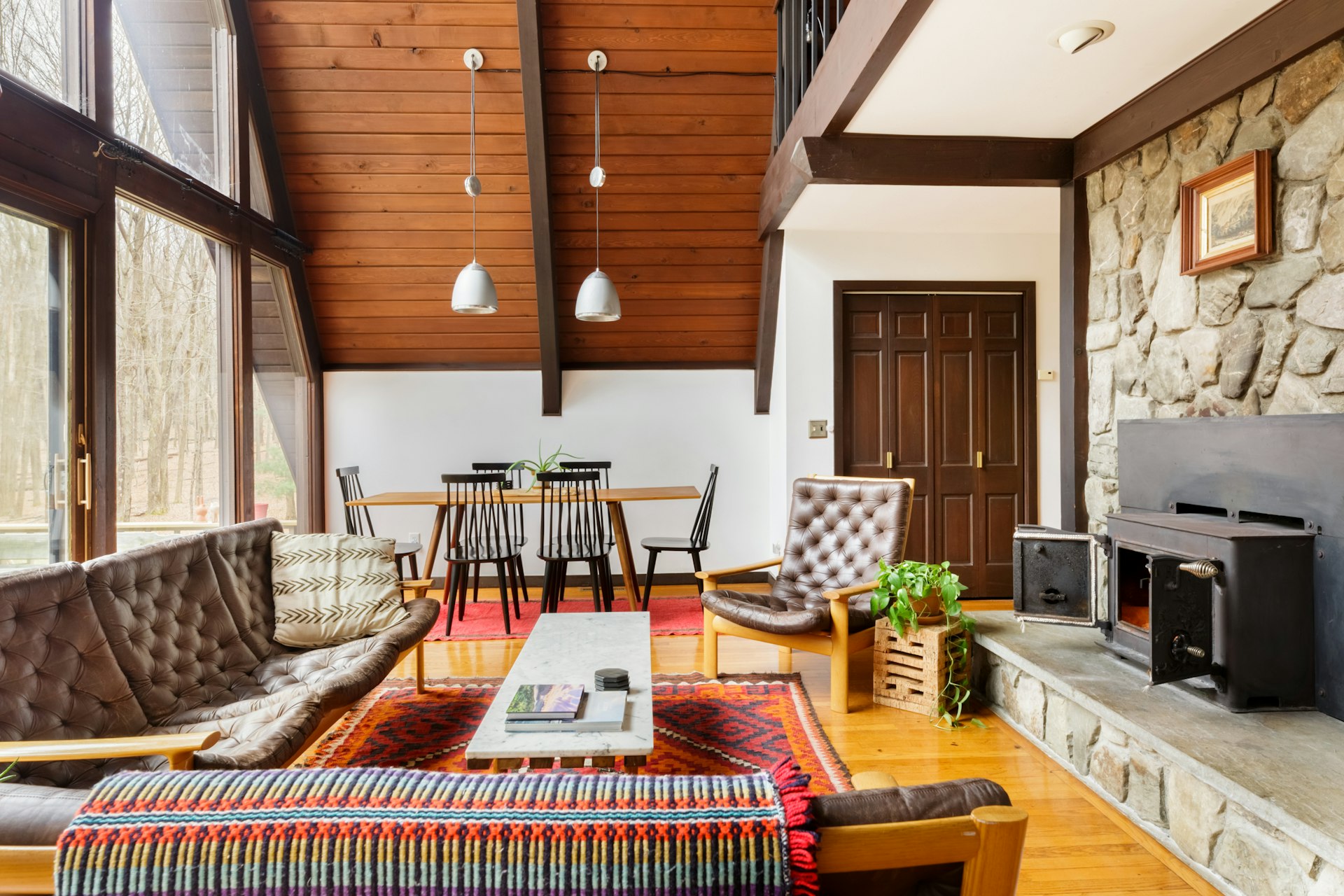The mid-century modern living room of an A-frame cabin in the Hudson Valley
