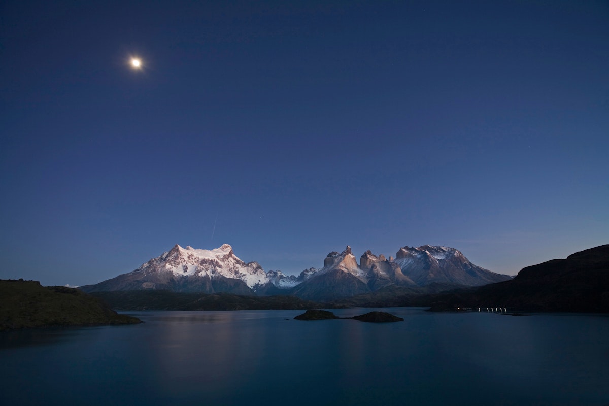 Dawn with moon at the Torres del Paine massif at Lake Lago Pehoe, National Park Torres del Paine, Patagonia, Chile
