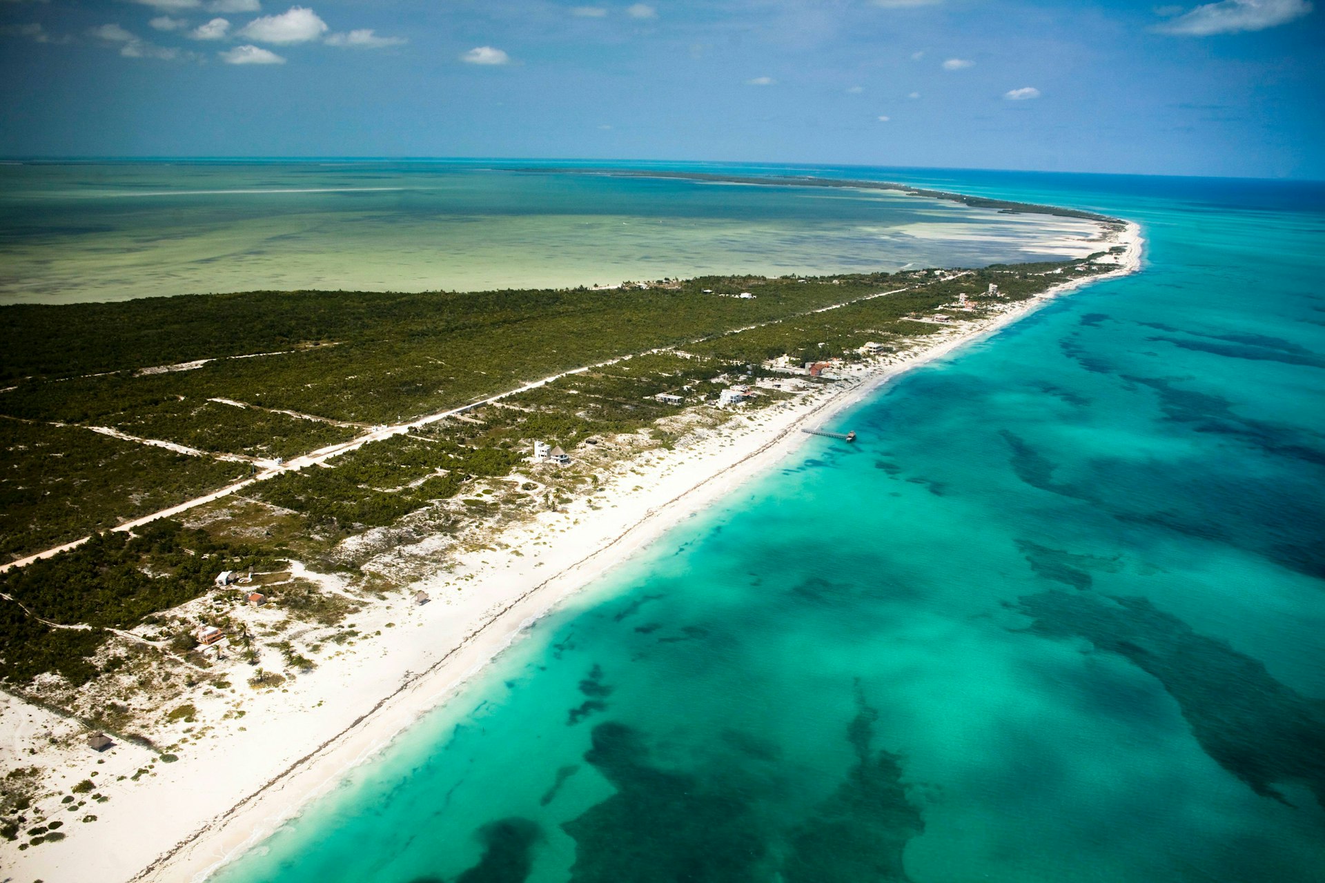 An aerial view of a pristine and undeveloped stretch of coastline with turquoise seas