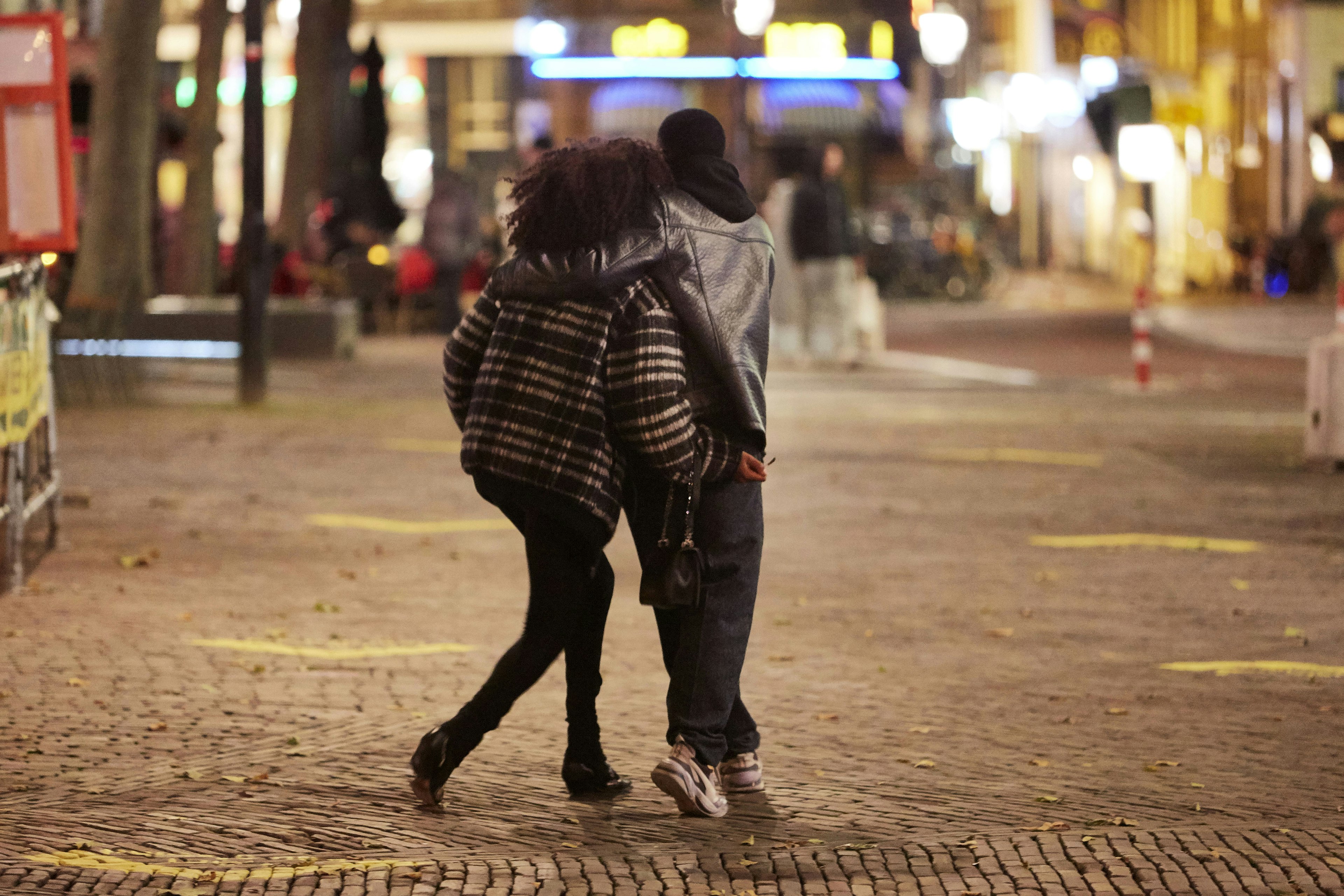 A couple walks out of a café on Rembrandtplein