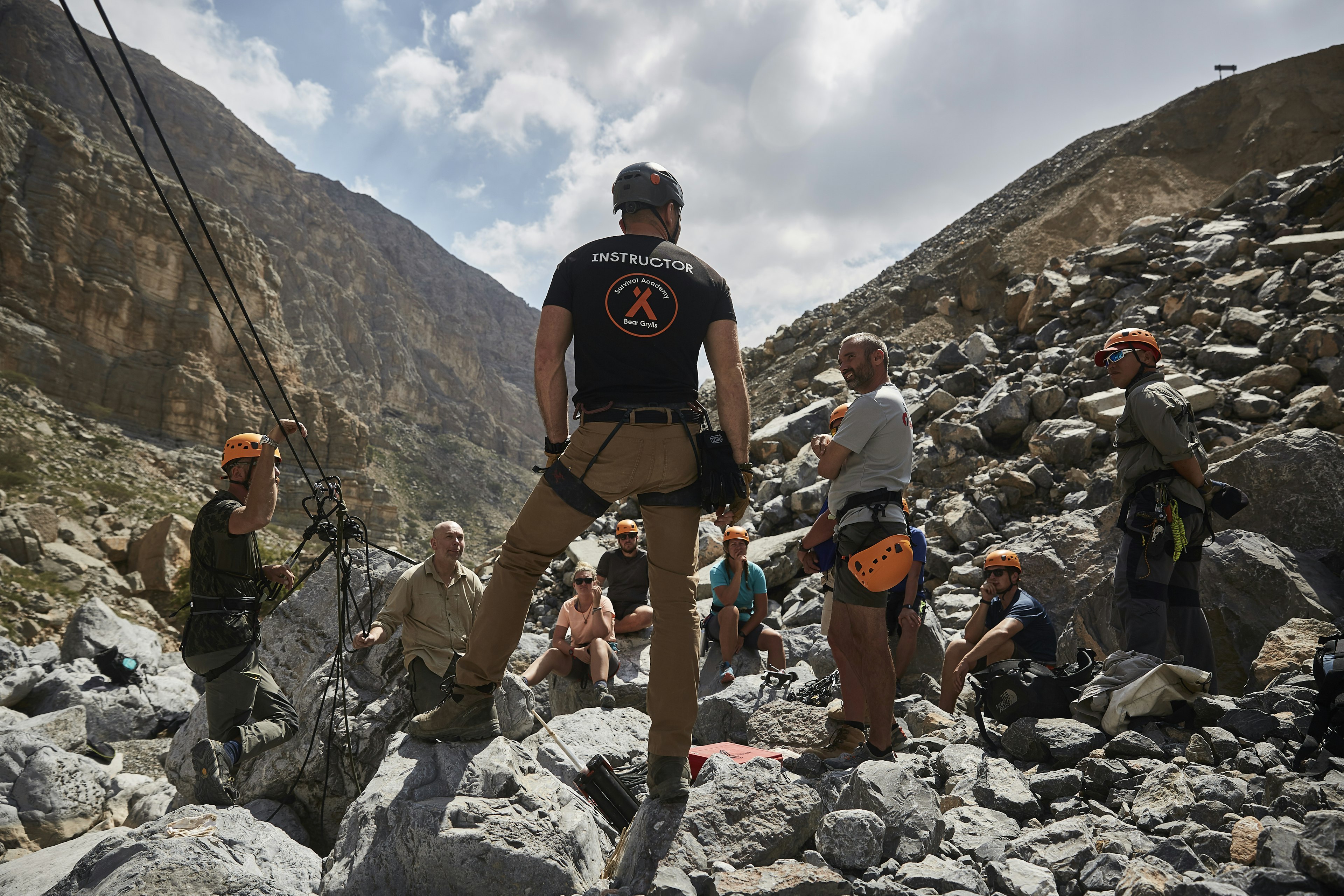 A survival course instructor addresses a group of participants