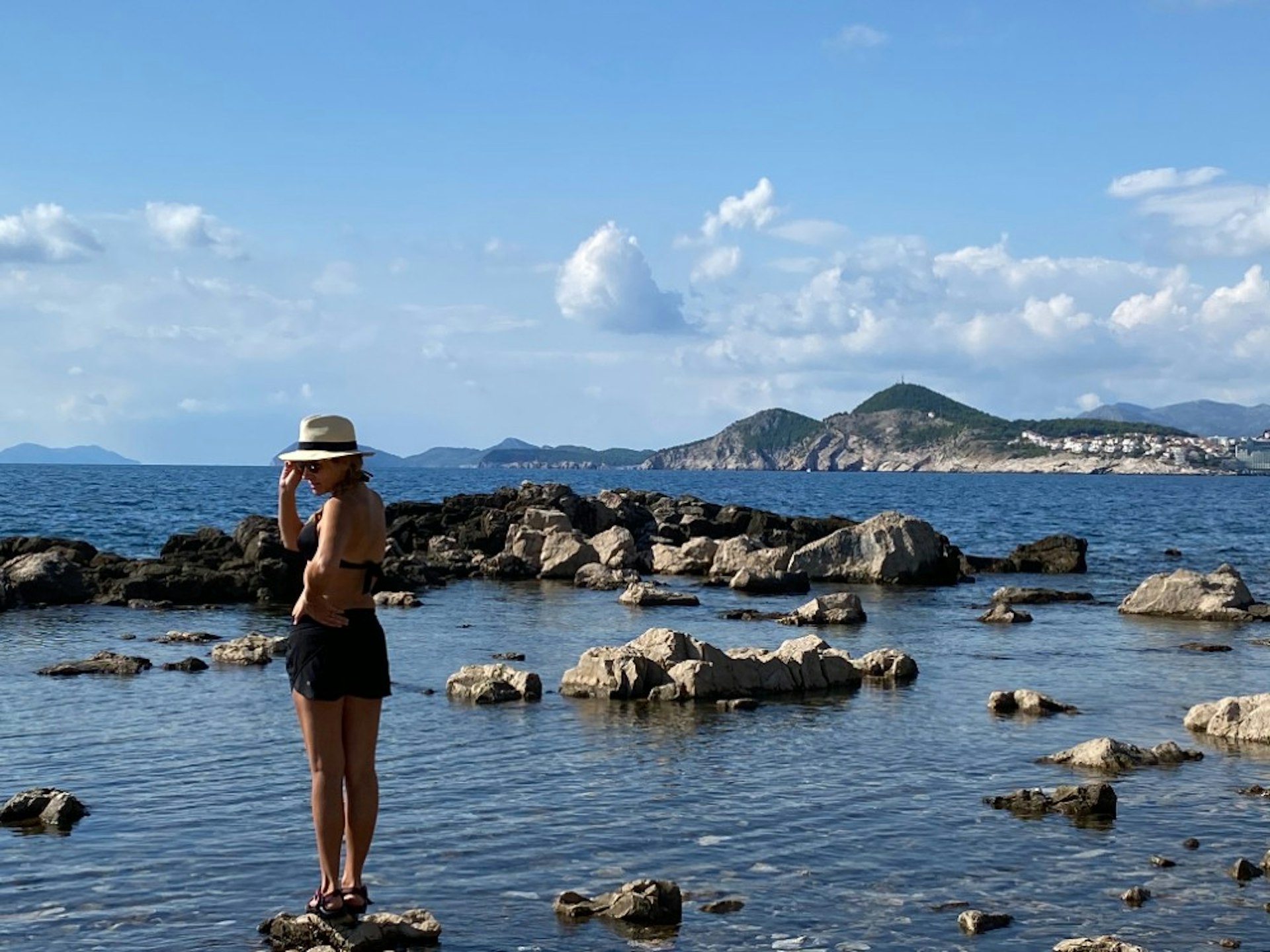 A woman exploring the tide pools on Lokrum Island in Croatia