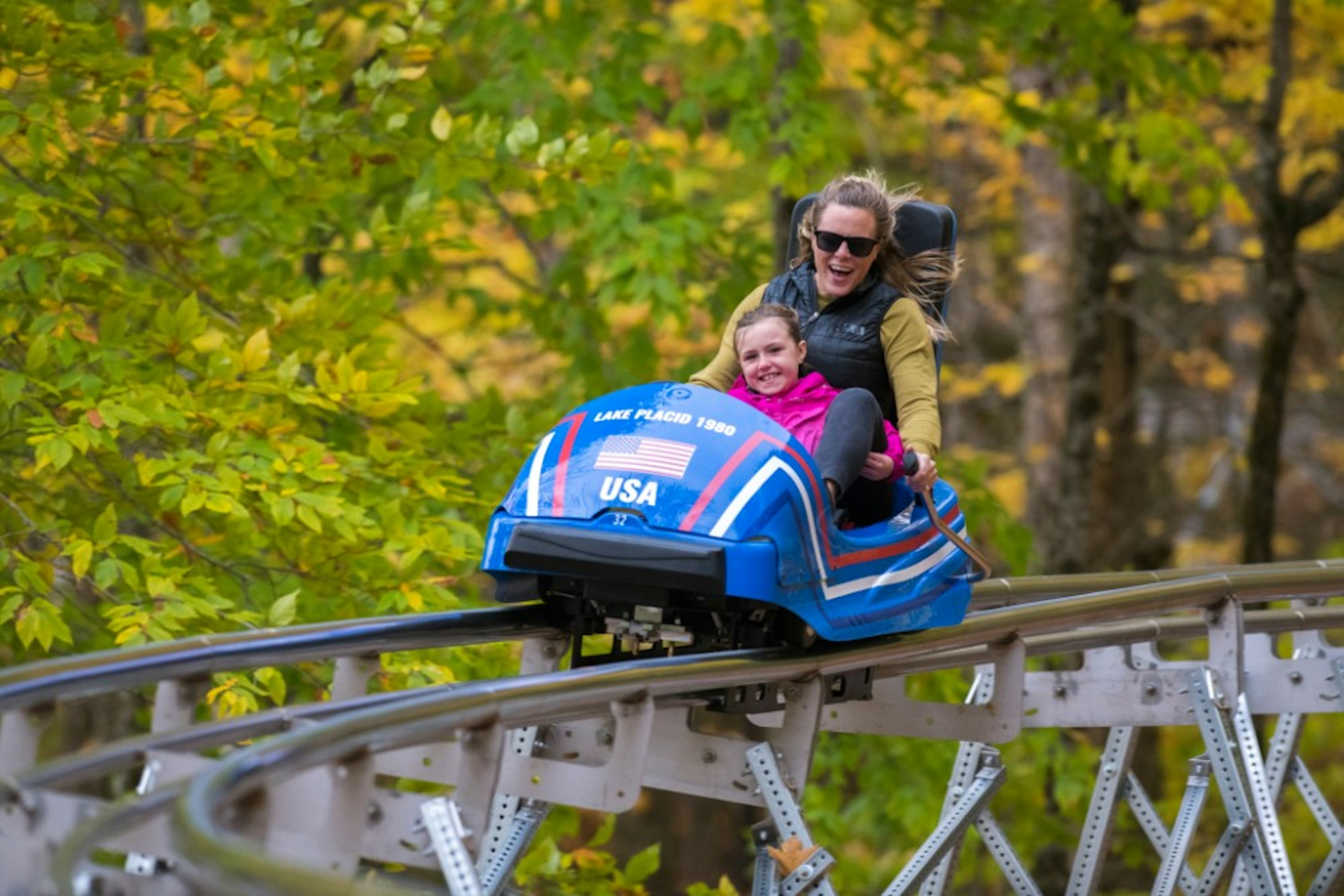 A woman and child riding the Cliffside Coaster in New York