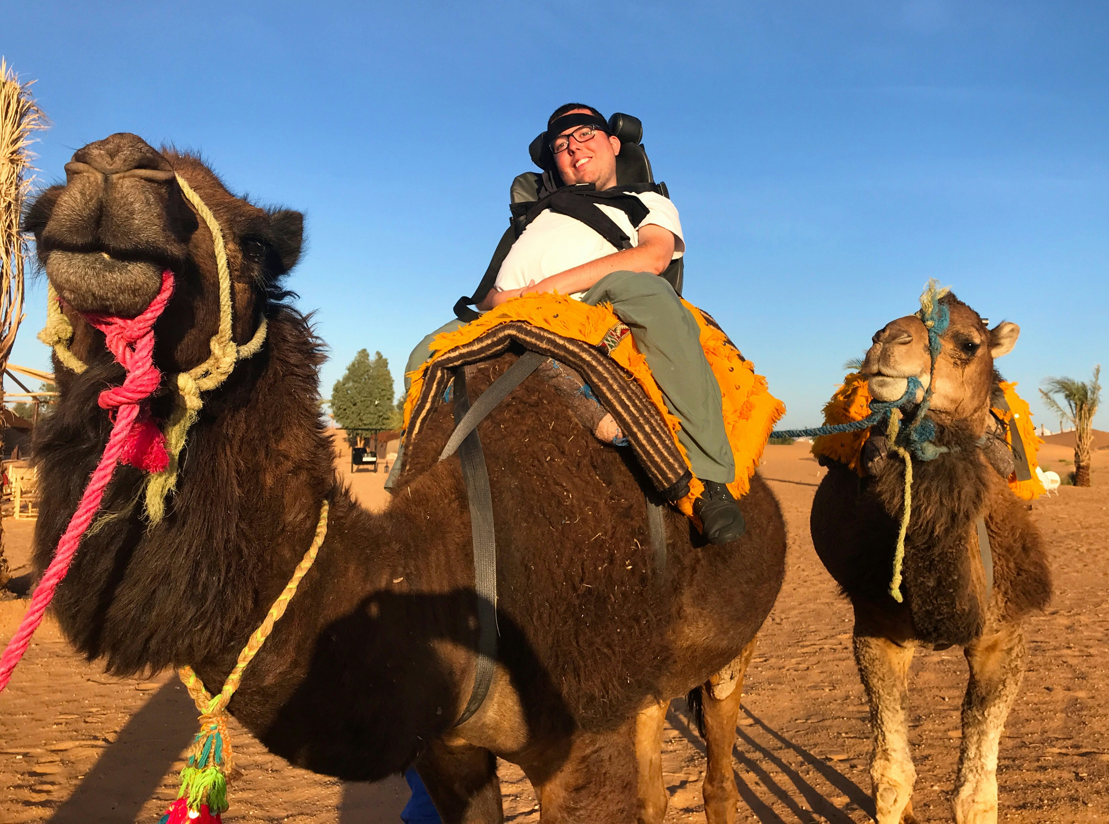 A disabled traveler atop a camel in Morocco