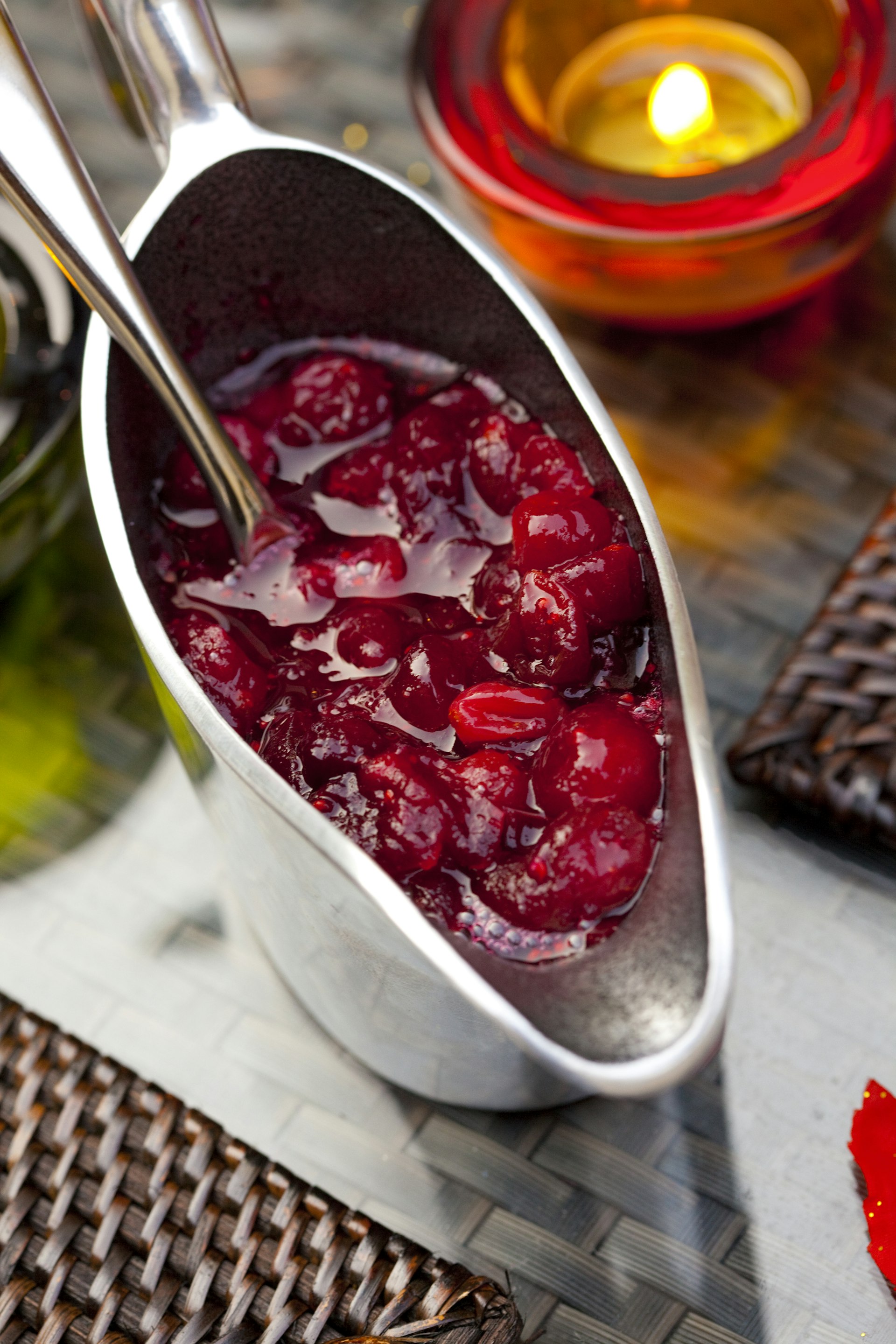 Cranberry sauce in pitcher on table