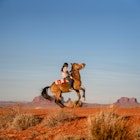 A Dine boy rides his horse in the Navajo Nation in the southwestern United States