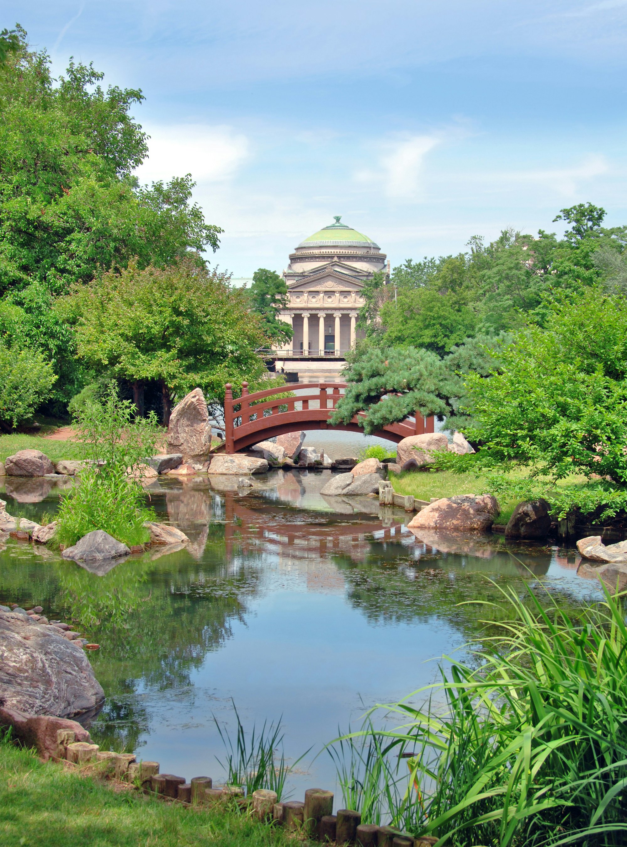Japanese bridge at Osaka Garden in Jackson Park. The Museum of Science and Industry is in the background.