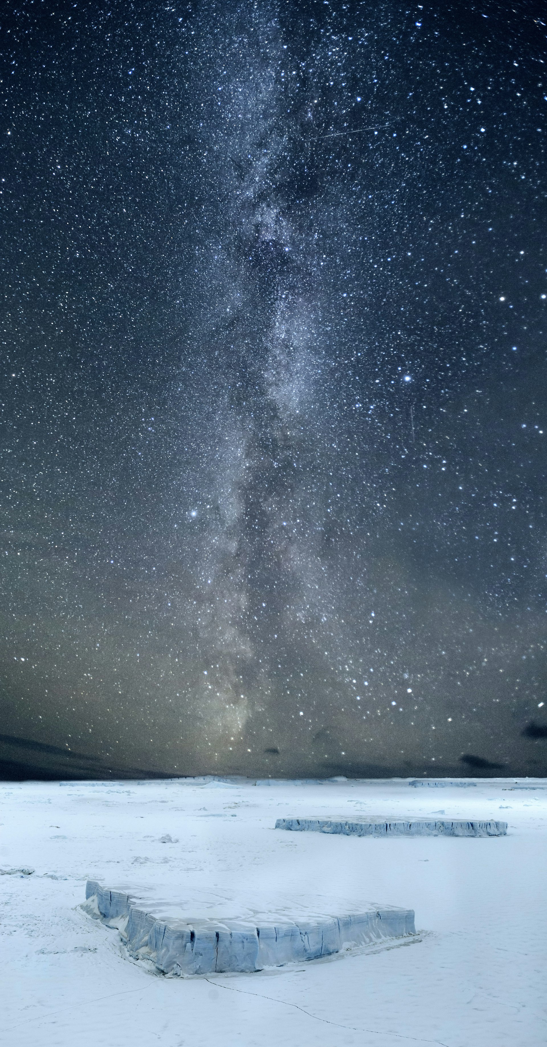 The Milky Way over Antarctica, with millions of stars in the dark sky above a white snowy landscape