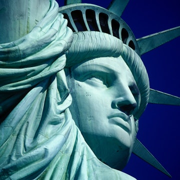 Cropped Image Of Statue Of Liberty Against Clear Blue Sky