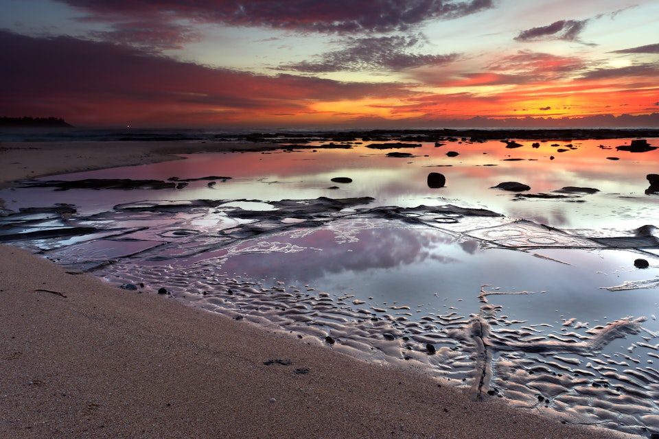Sunrise over rock pools on the southern end of Shelley beach.
