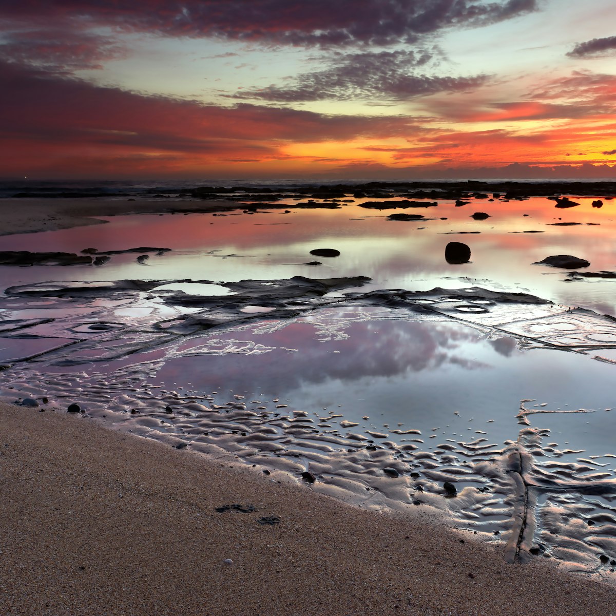 Sunrise over rock pools on the southern end of Shelley beach.