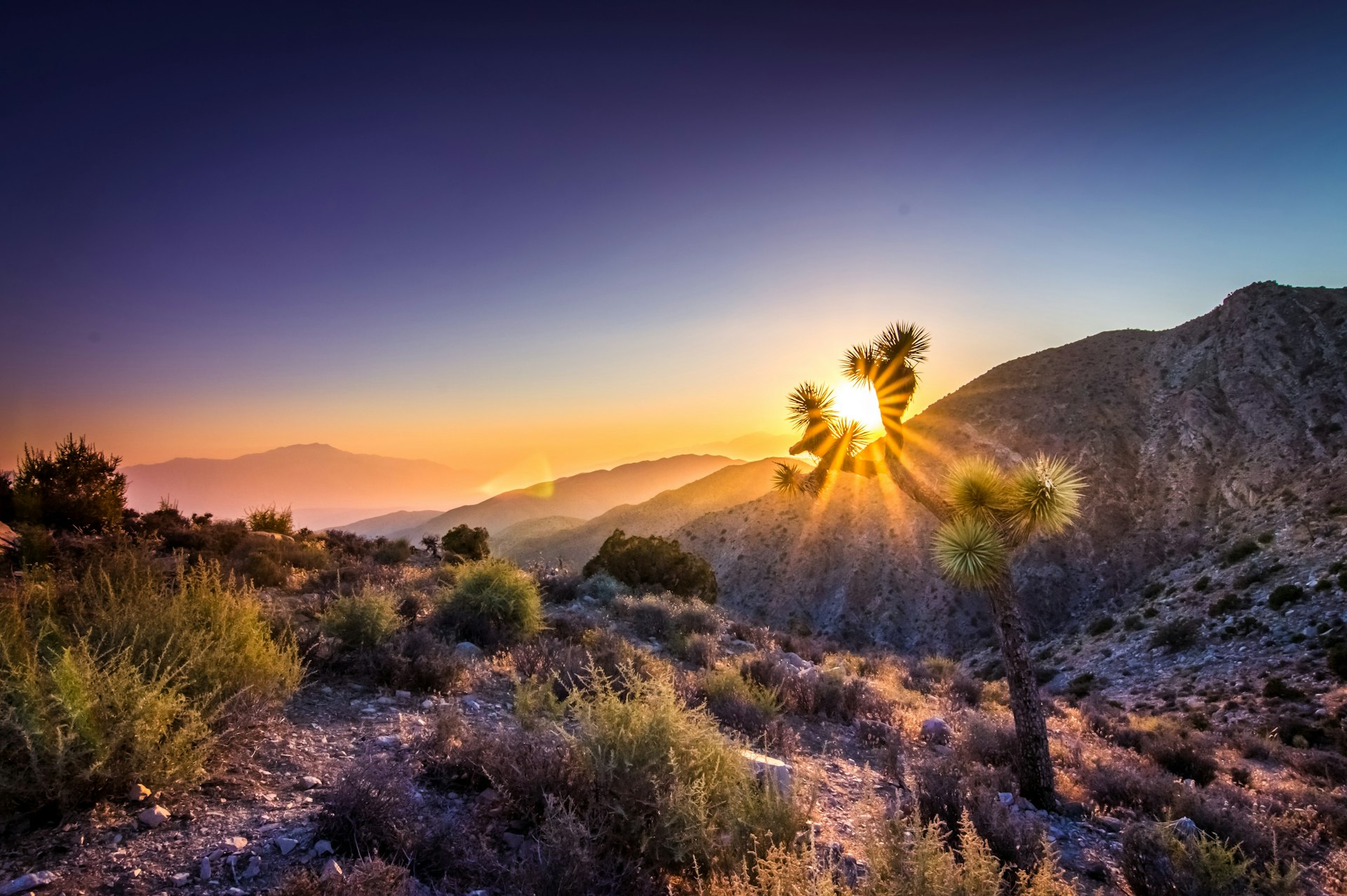 Scenic View Of Silhouette Mountains Against Sky At Sunset