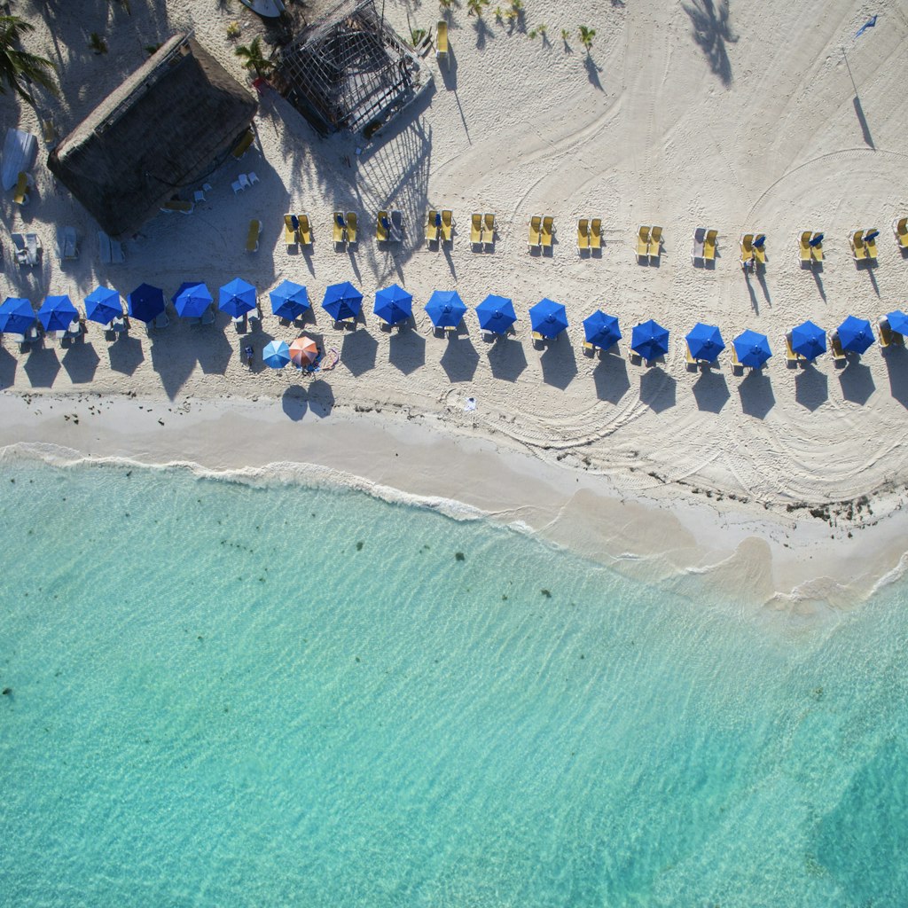 Beach umbrellas line the beach of Isla Mujeres, Aerial view