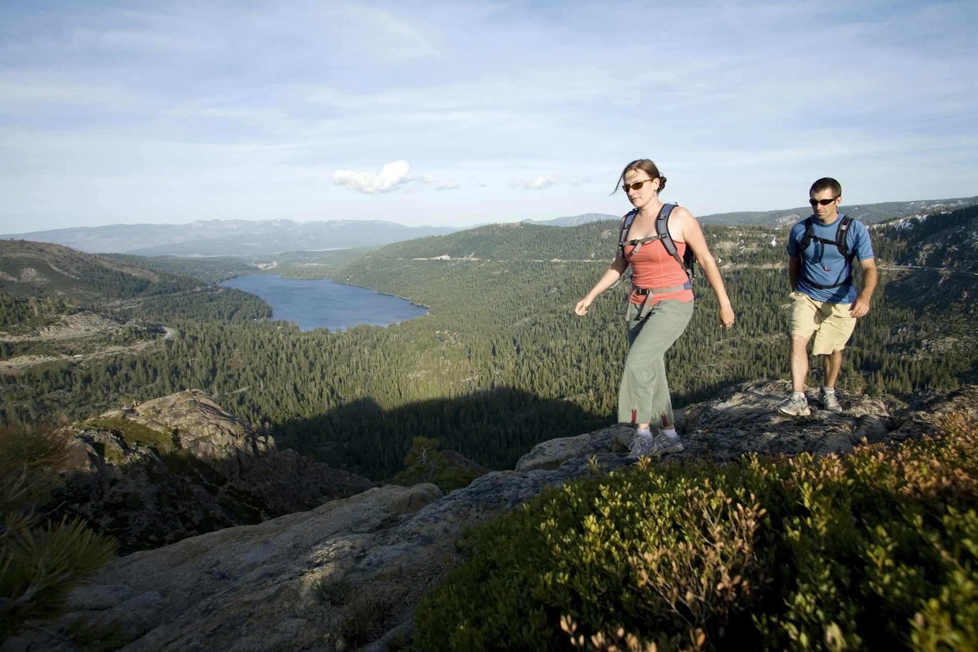 Young woman and man hiking near Donner Pass, CA.