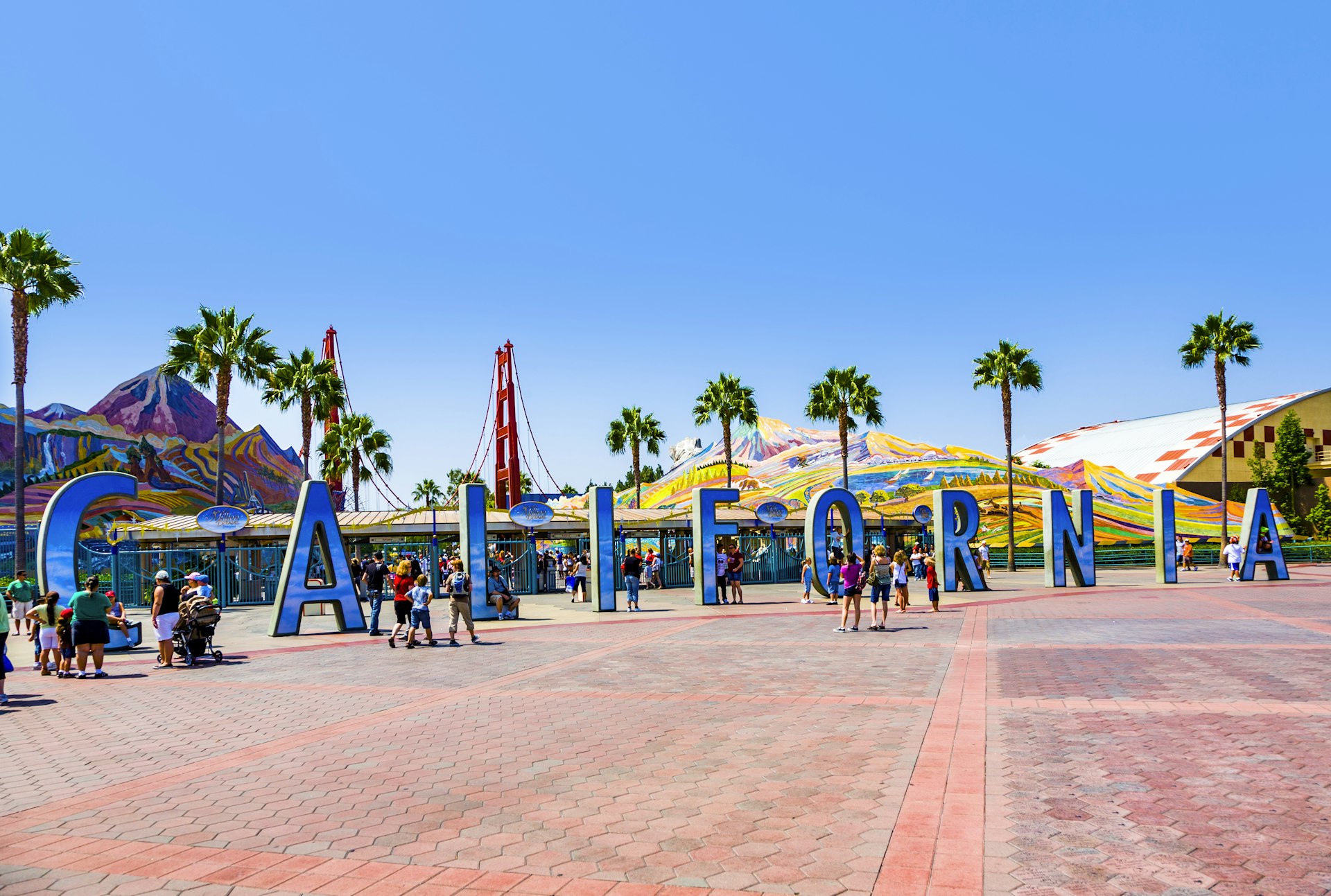 people visit disneyland and walk over commemorative bricks with names in terracotta