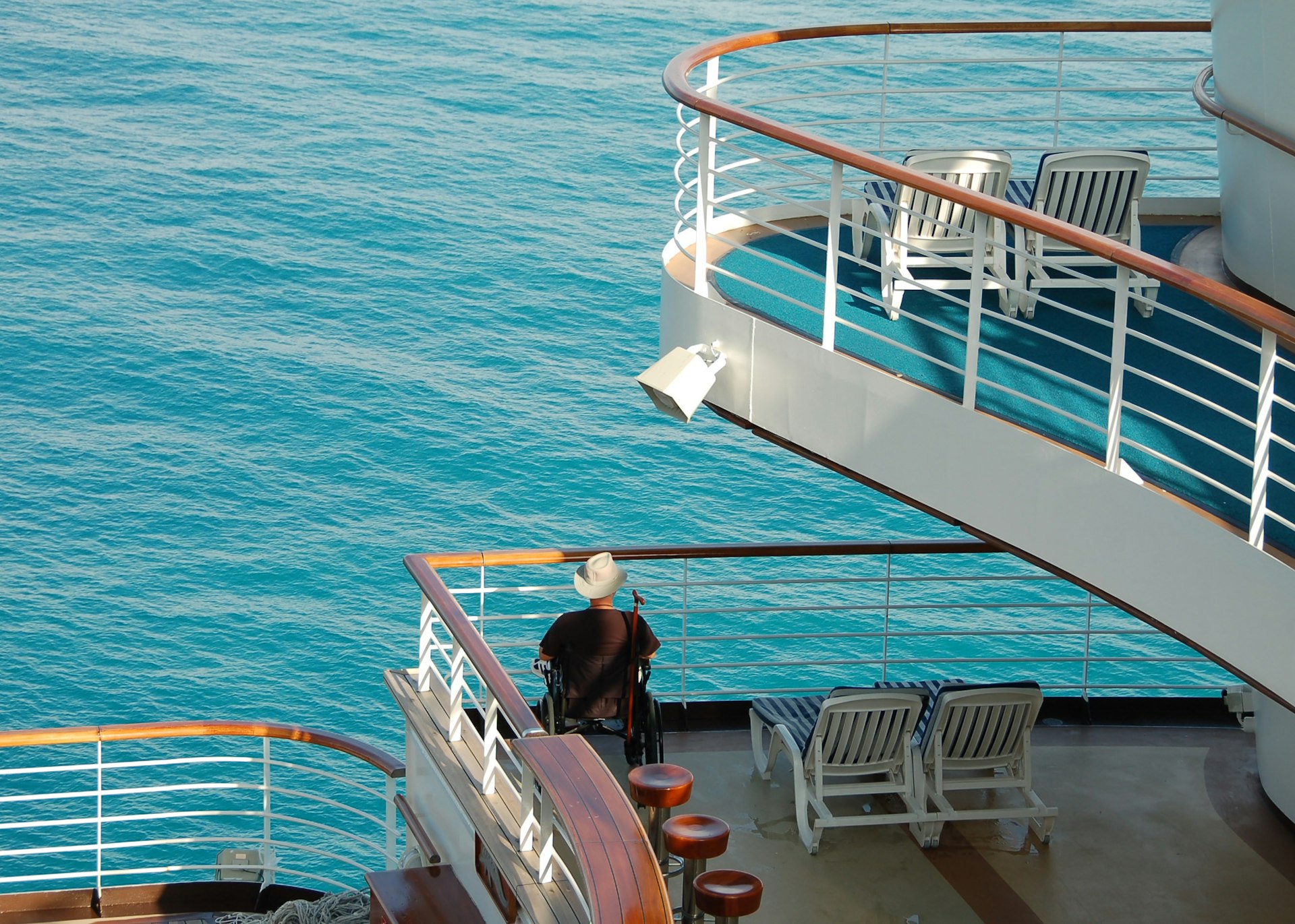 A wheelchair user outside on the deck of a cruise ship. 