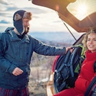 Hiking couple is resting after long trekking in mountain