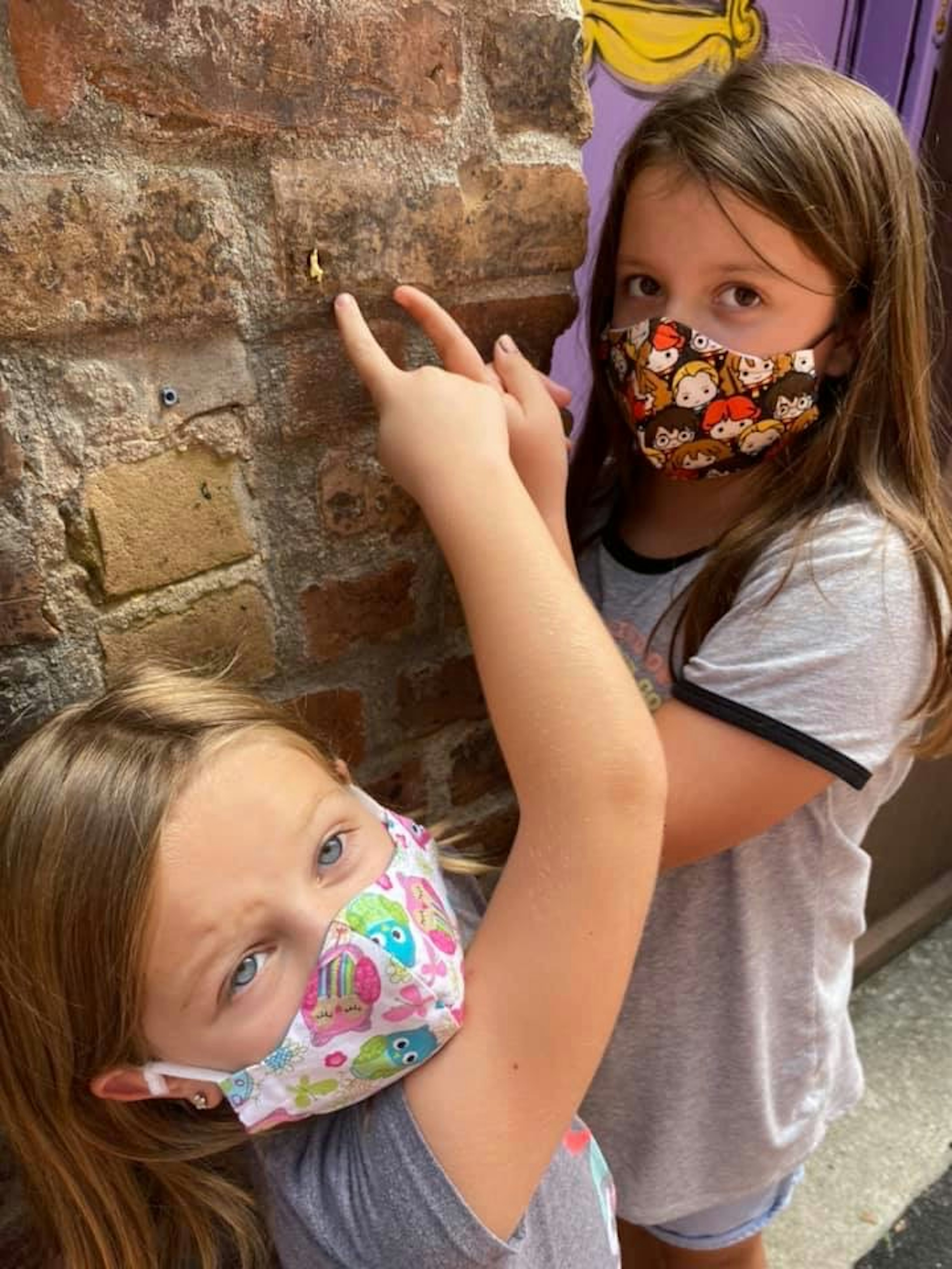 Children discover miniature vignettes at an outdoor museum in Mississippi