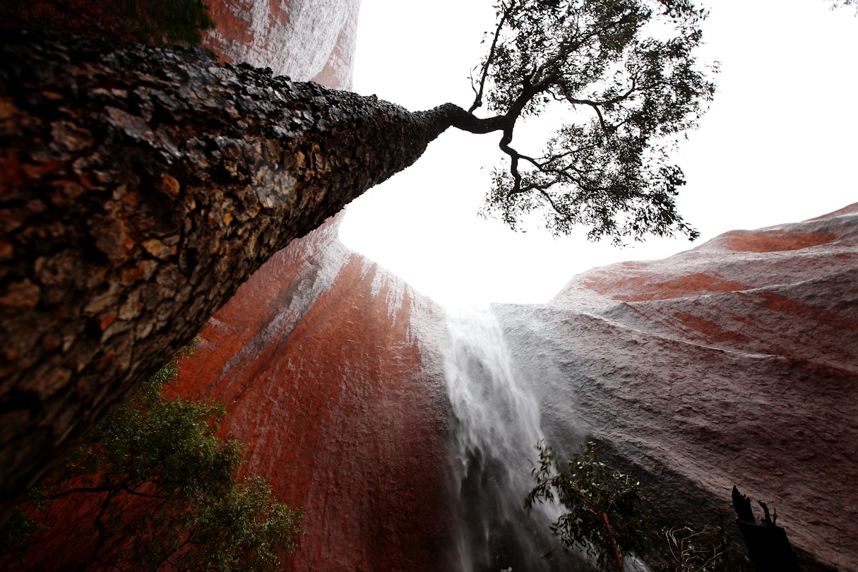 ULURU-KATA TJUTA NATIONAL PARK, AUSTRALIA - NOVEMBER 28: A waterfall is seen in Kantju Gorge as it rains at Uluru on November 28, 2013 in Uluru-Kata Tjuta National Park, Australia. Uluru/ Ayers Rock is a large sandstone formation situated in central Australia approximately 335km from Alice Springs. The site and its surrounding area is scared to the Anangu people, the Indigenous people of this area and is visited by over 250,000 people each year.  (Photo by Mark Kolbe/Getty Images)