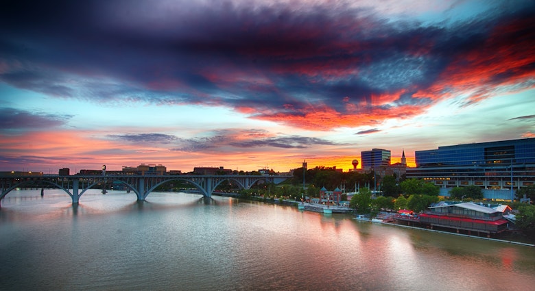 Knoxville, Tennessee skyline at sunset with the Tennessee River in the foreground