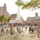 Bikes and people crowd Dam Square.