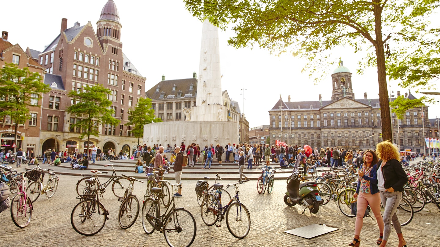 Bikes and people crowd Dam Square.