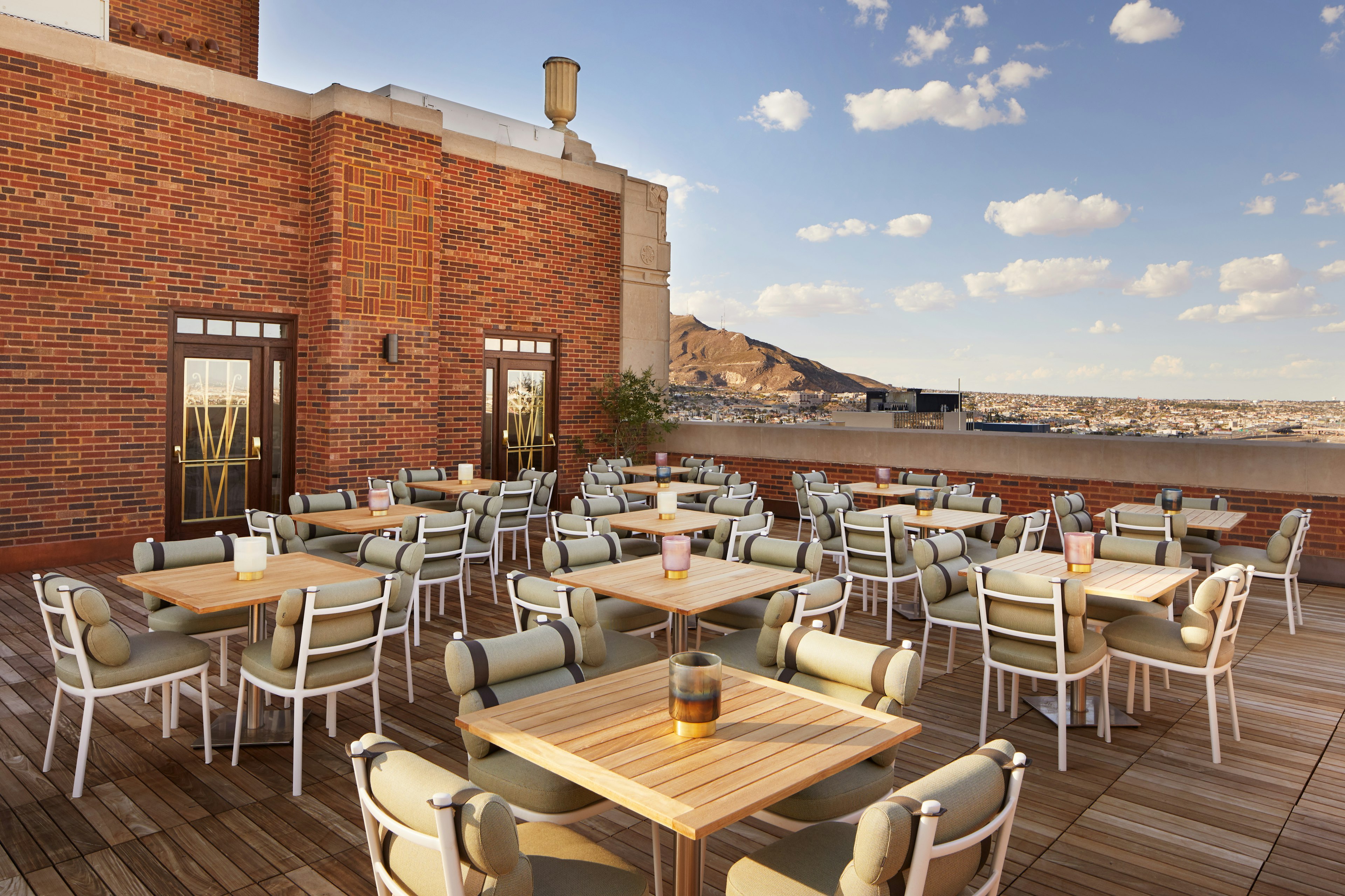 A rooftop bar with views over the city and hills beyond