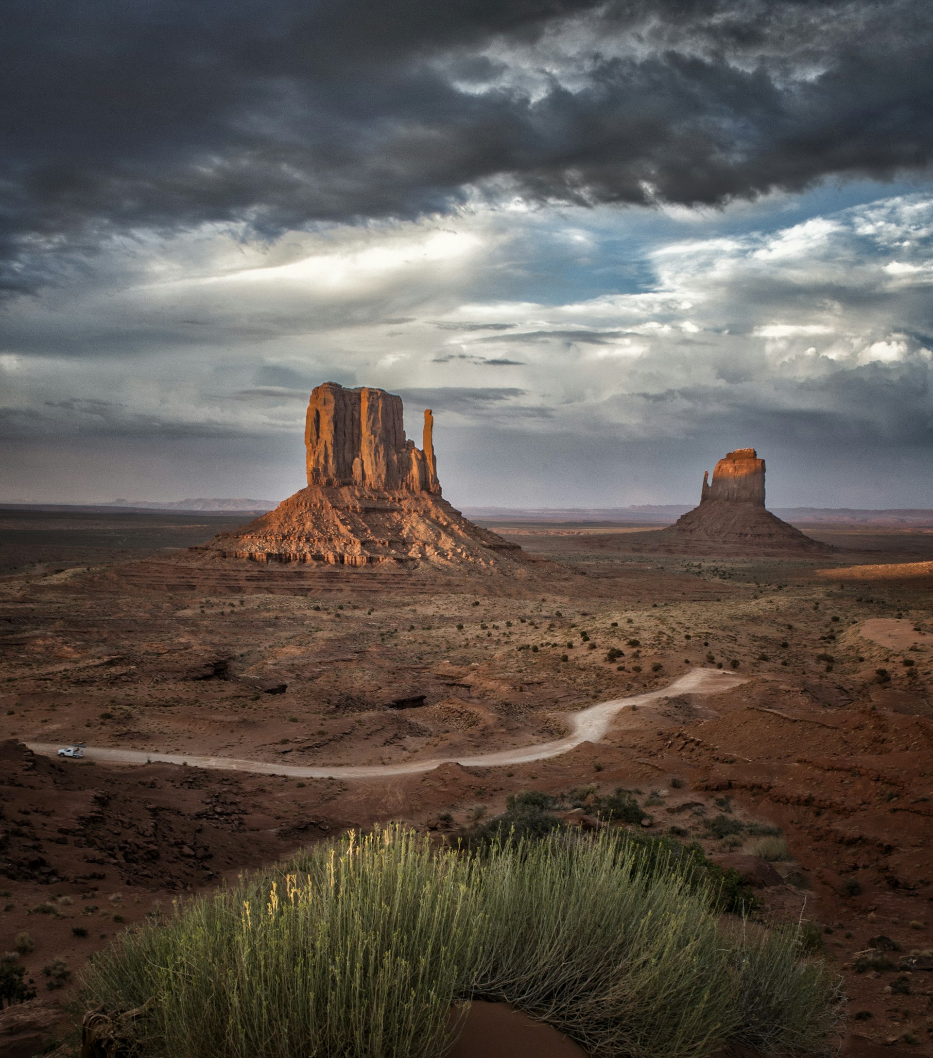 A grey sky threatening storms over the tall red rocky outcrops of Monument Valley
