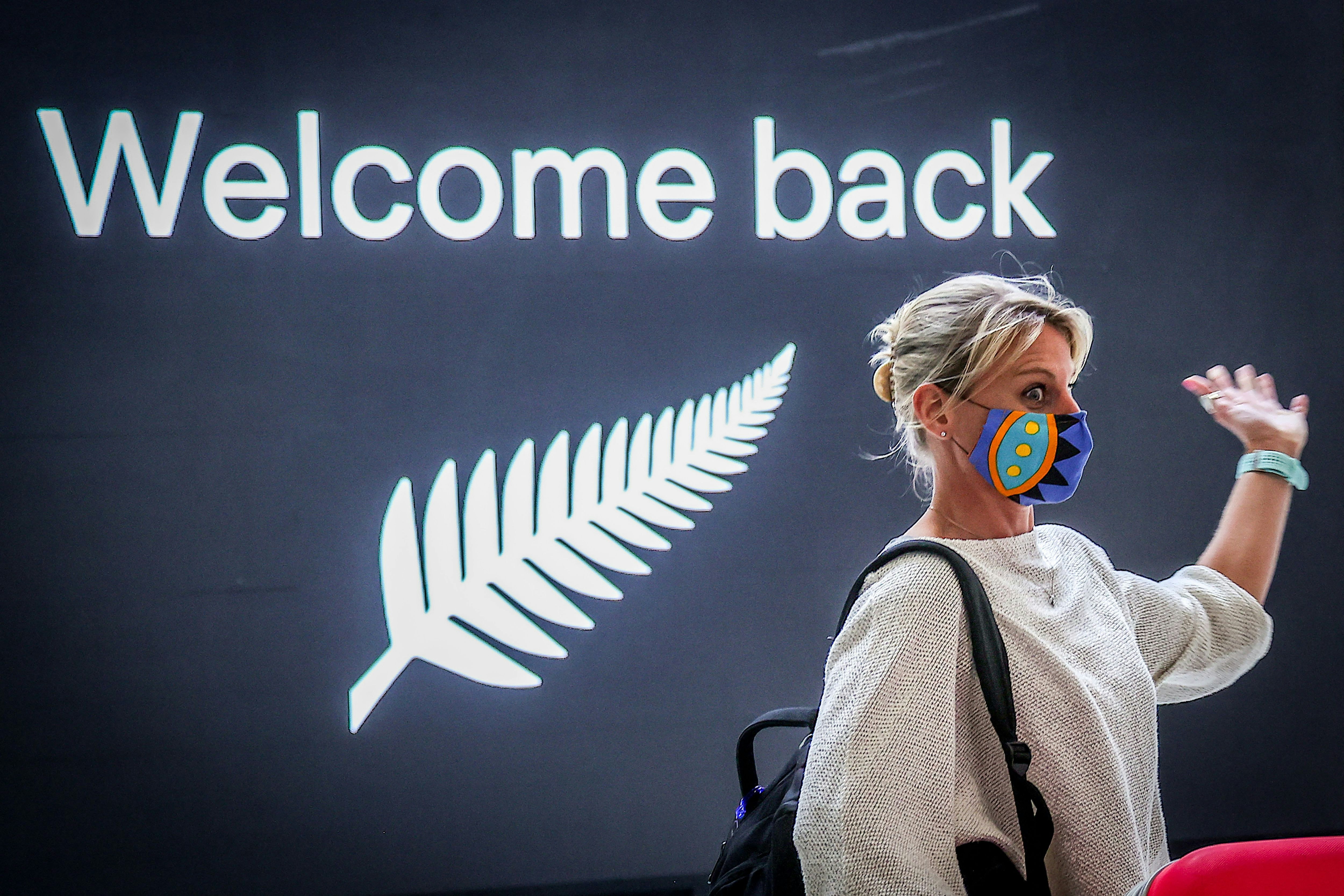 A passenger reacts upon arrival from New Zealand at Sydney International Airport on October 16, 2020, after Australias border rules were relaxed under a new one-way trans-Tasman travel agreement that allow travellers from New Zealand to visit New South Wales without having to quarantine amid the Covid-19 coronavirus pandemic. (Photo by DAVID GRAY / AFP) (Photo by DAVID GRAY/AFP via Getty Images)