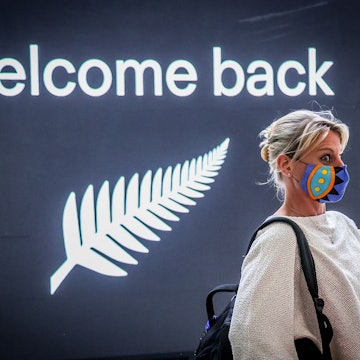 A passenger reacts upon arrival from New Zealand at Sydney International Airport on October 16, 2020, after Australias border rules were relaxed under a new one-way trans-Tasman travel agreement that allow travellers from New Zealand to visit New South Wales without having to quarantine amid the Covid-19 coronavirus pandemic. (Photo by DAVID GRAY / AFP) (Photo by DAVID GRAY/AFP via Getty Images)