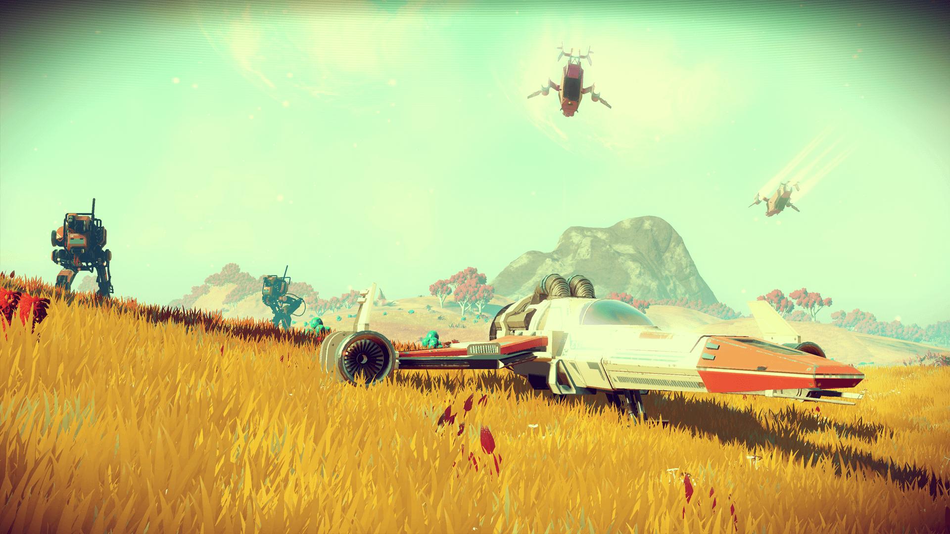 A small space ship is parked in a meadow on an alien planet featured in the video game No Man's Sky. Beyond the ship, a mountain range is visible, as are some advanced robotic lifeforms.