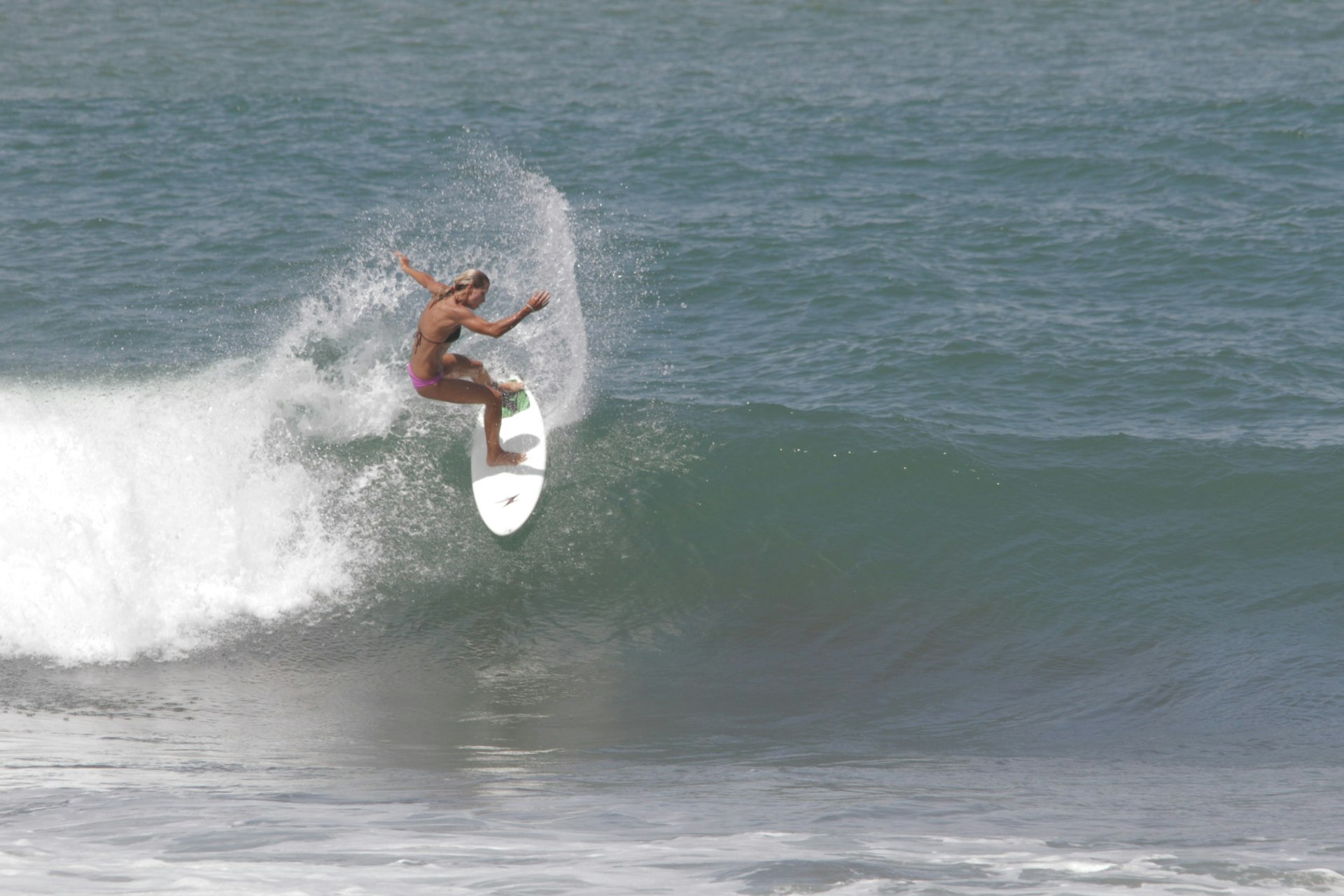 A woman surfing a wave at Playa Hermosa