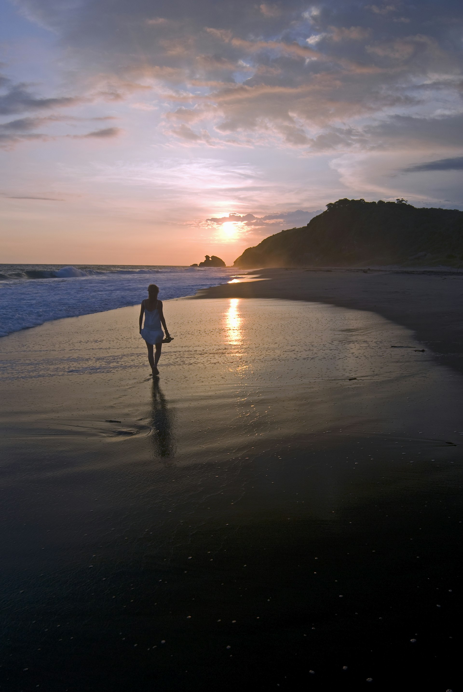 Young woman walking on beach