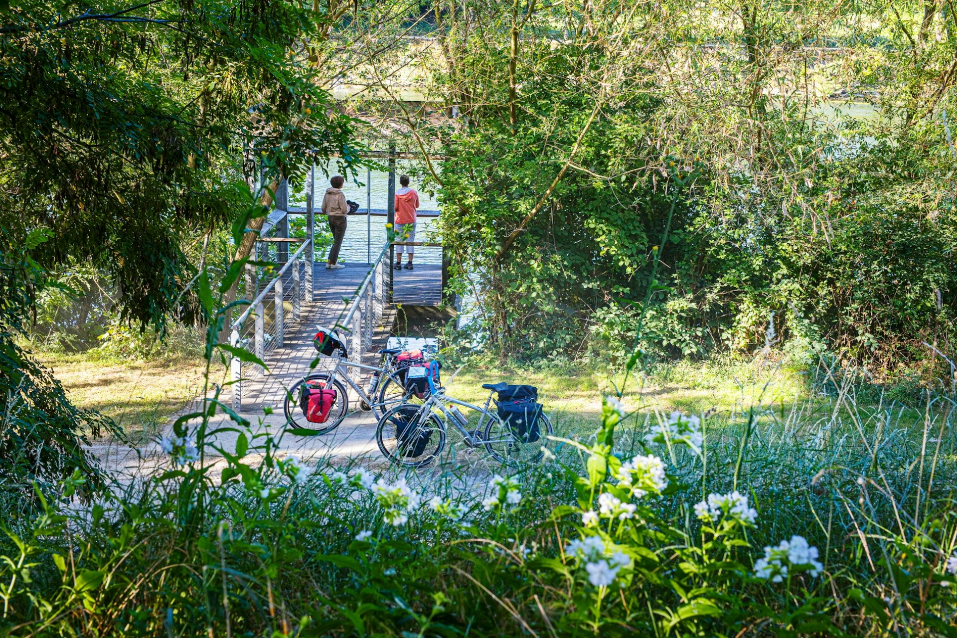 Two people admiring the view on the Seine a Velo cycle route in France