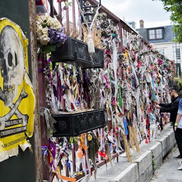 London, 25th July 3025.------- Cross Bones, a pauper's burial ground in The Borough, Southwark, south London, where excavations for the construction of London Underground's Jubilee line have found f a highly overcrowded graveyard with bodies piled on top of one another. It is believed by John Constable, a local author, to have been established originally as an unconsecrated graveyard for prostitutes. A local group, Friends of Cross Bones, is campaigning for a permanent memorial garden, and the graveyard gates in Redcross Way are permanently decorated by messages, ribbons, flowers and other tokens; one day each month a short memorial vigil ceremony is held at the gates in the early evening. (Photo by NurPhoto/NurPhoto via Getty Images)