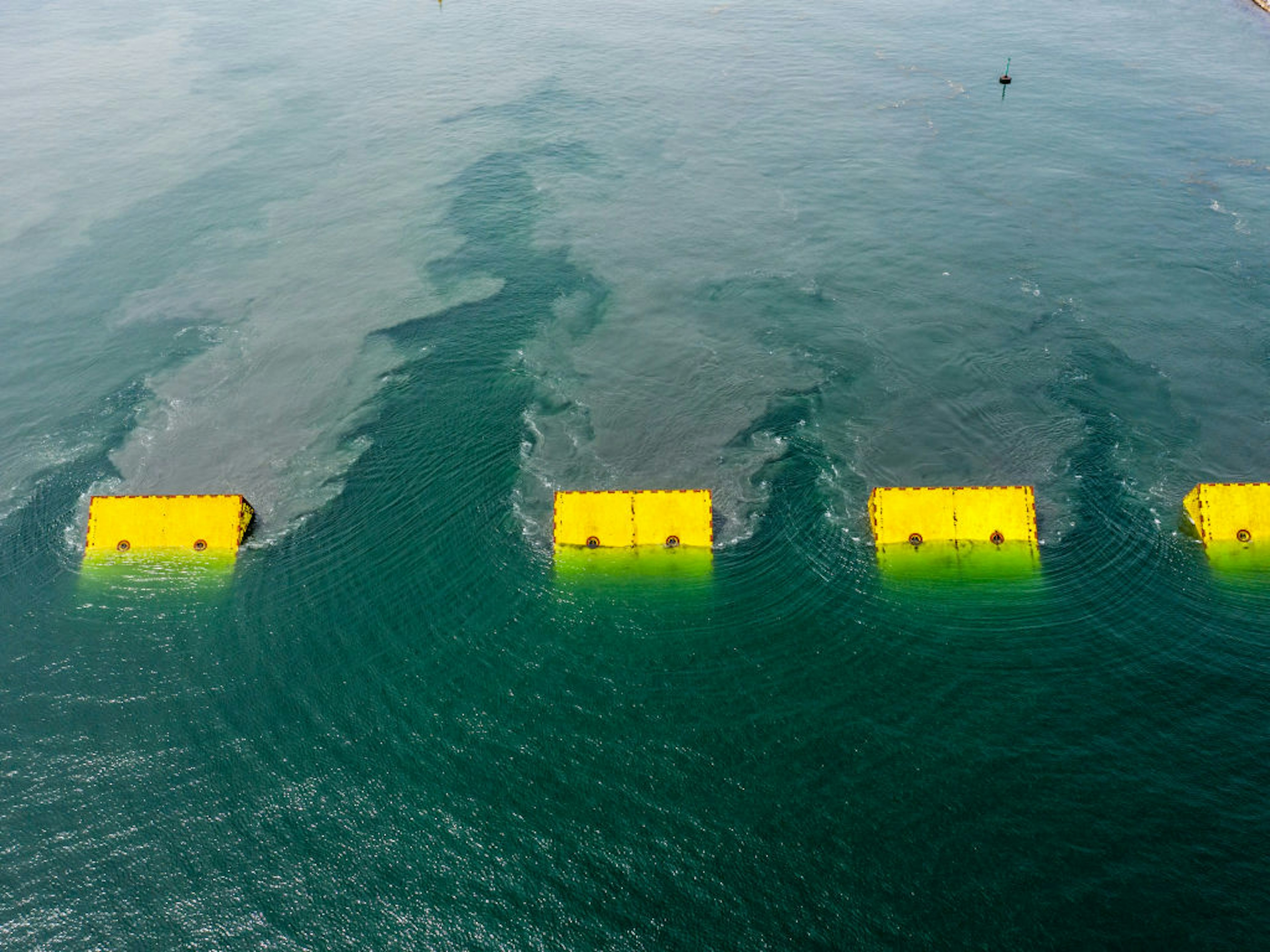 A picture of the yellow mose dams being lifted during a test run