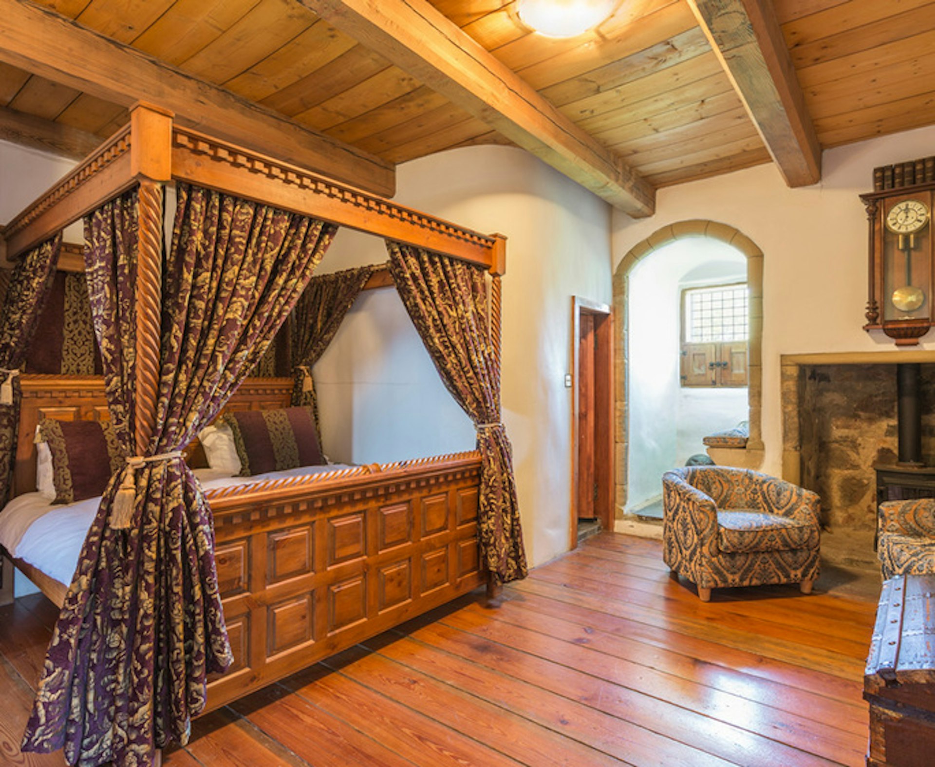 Four-poster bed in a luxury guest bedroom at Law Castle