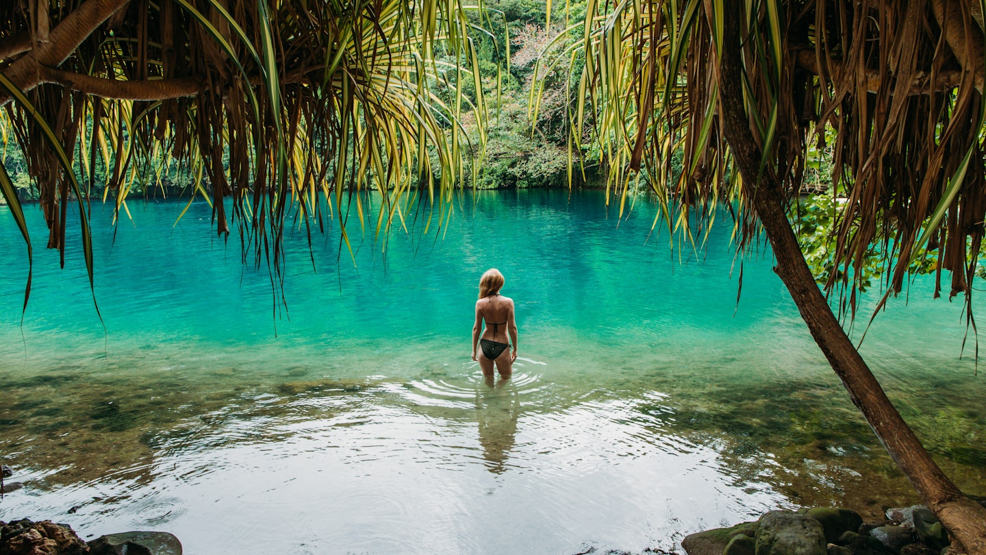Young woman standing in the Blue Lagoon in Jamaica.