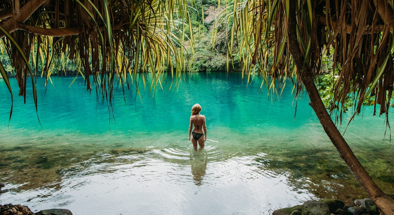 Young woman standing in the Blue Lagoon in Jamaica.