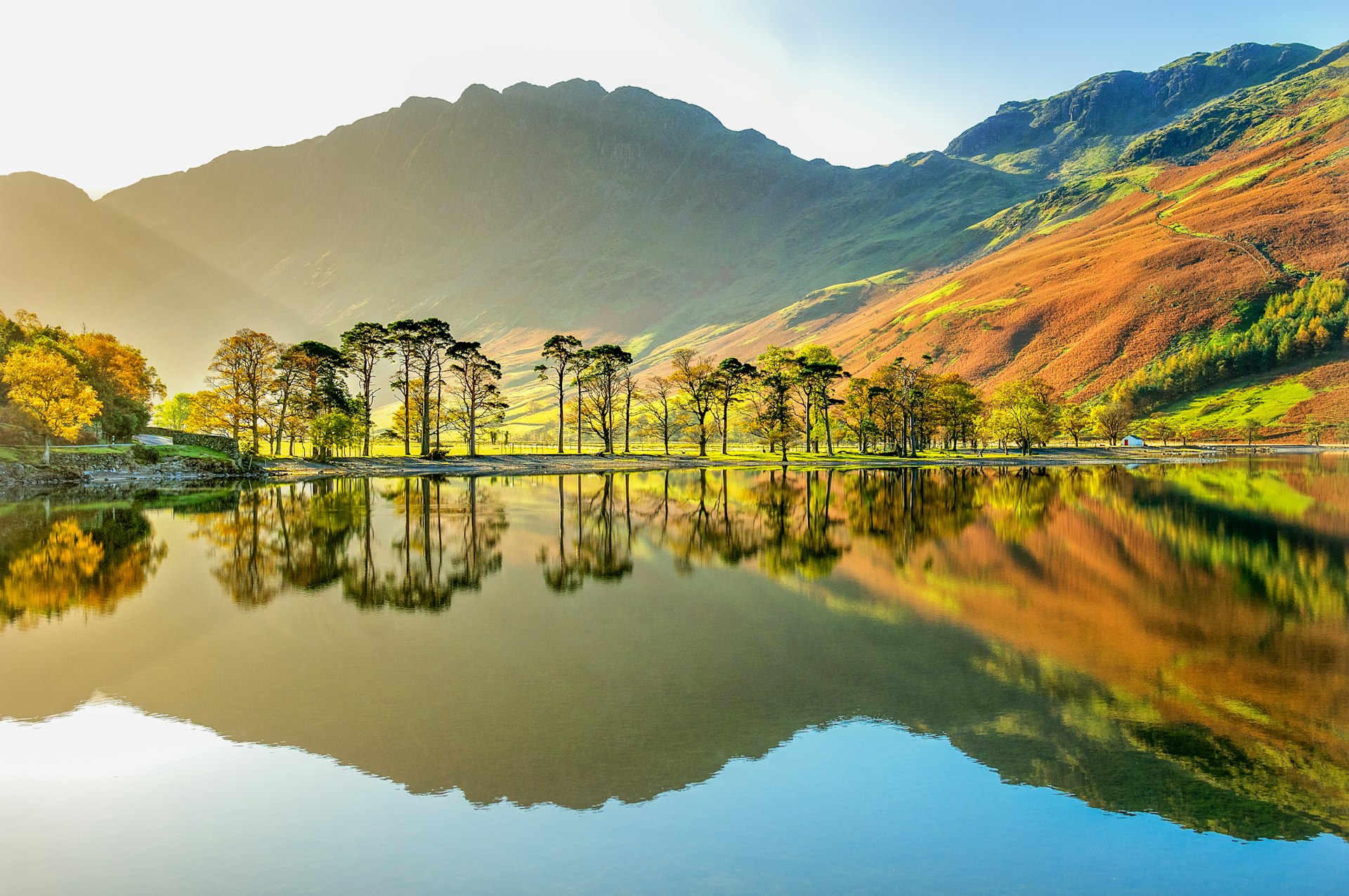 Lake with a reflection of the surrounding mountains during the early morning. 