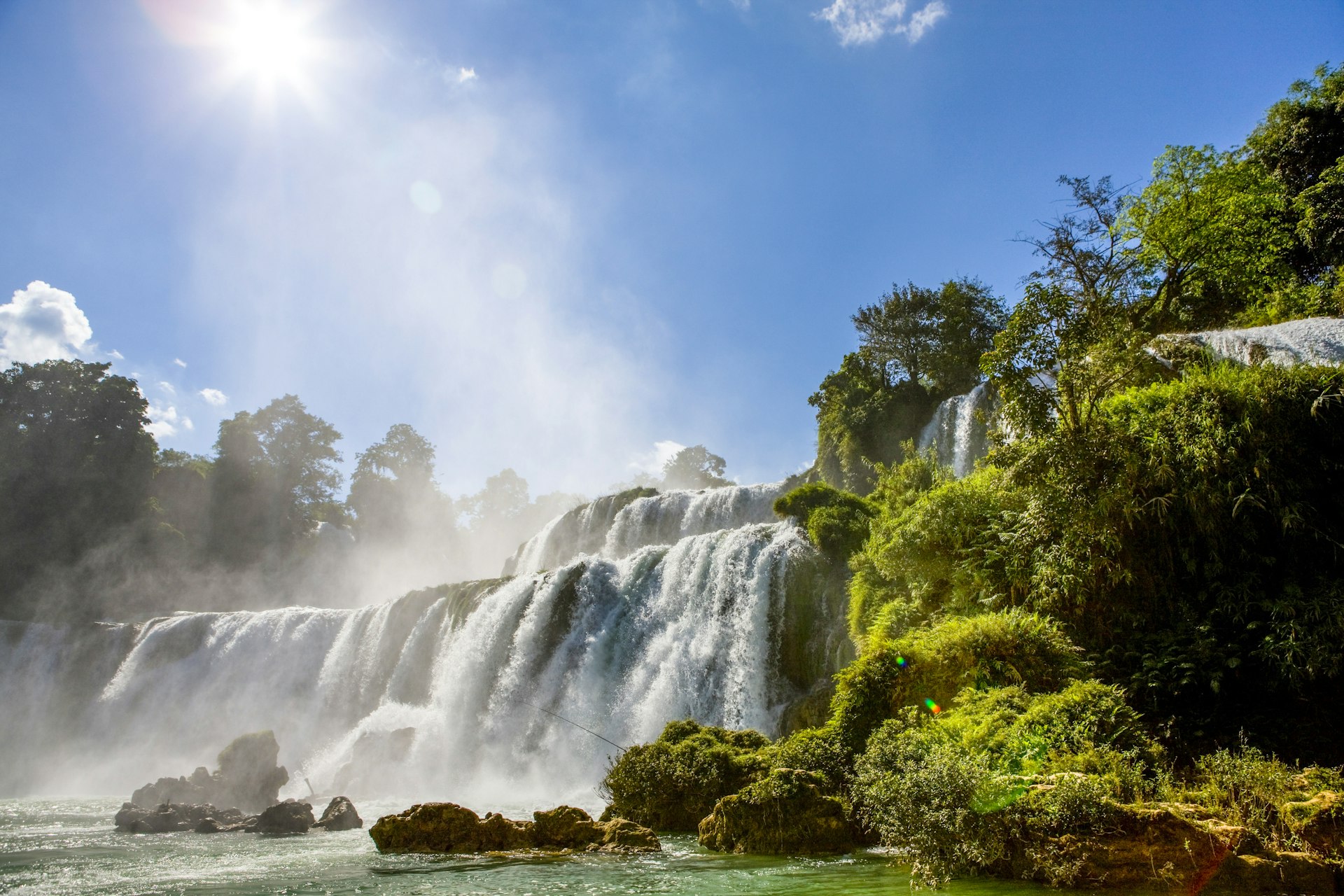 A huge waterfall located on the border of Vietnam and China. Vast quantities of water flow over the falls.