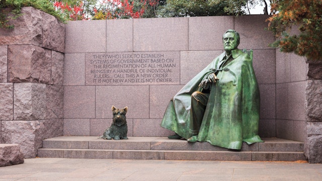 WASHINGTON, DC - NOVEMBER 16, 2014:  The statue of Franklin Delano Roosevelt and his dog on the National Mall in autumn is a major tourist attraction.