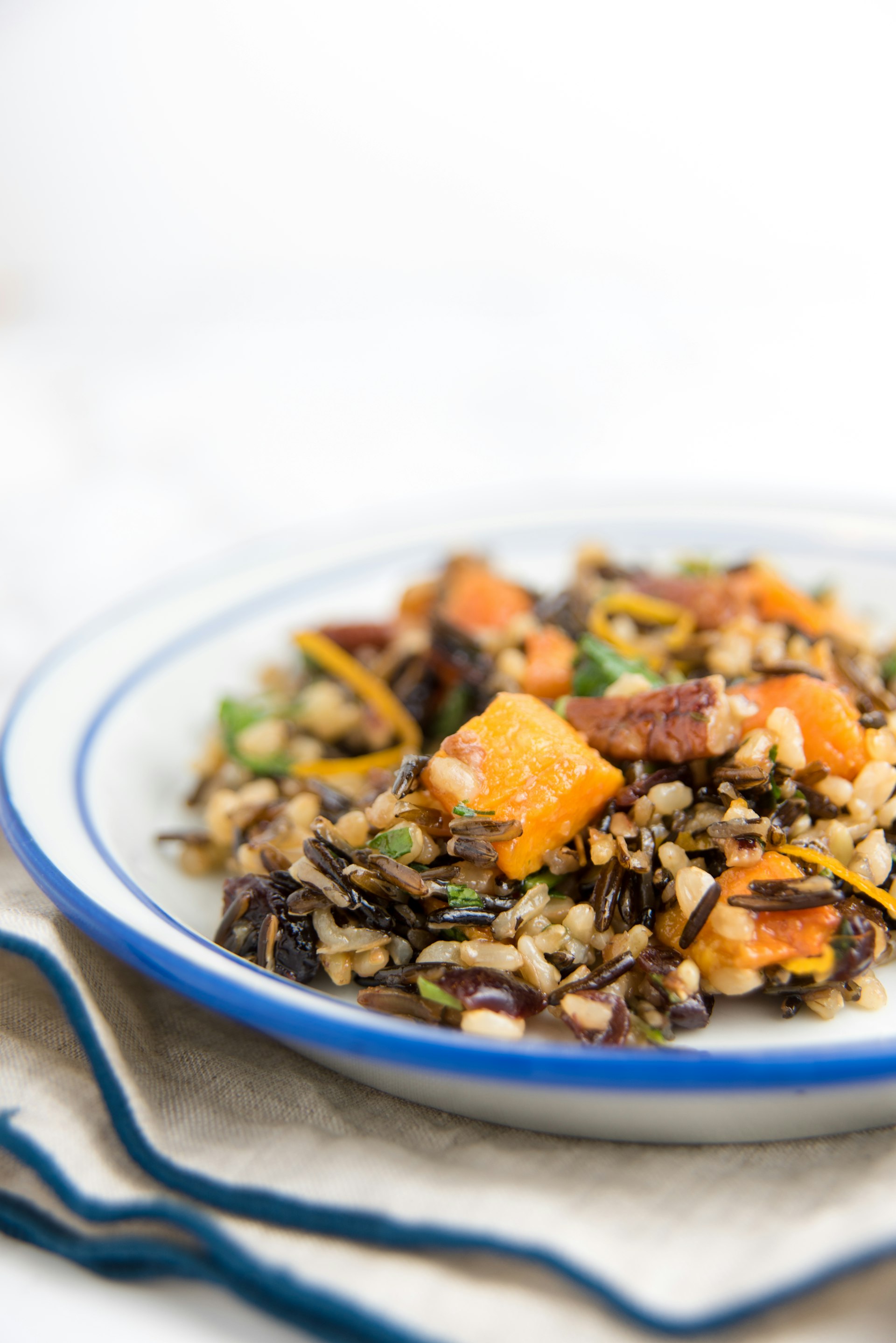 A plate with winter wild rice with yams and fresh herbs 