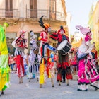 HAVANA, CUBA - APRIL 15,2015 : Colorful stiltwalkers dancing to the sound of cuban music in Old Havana.