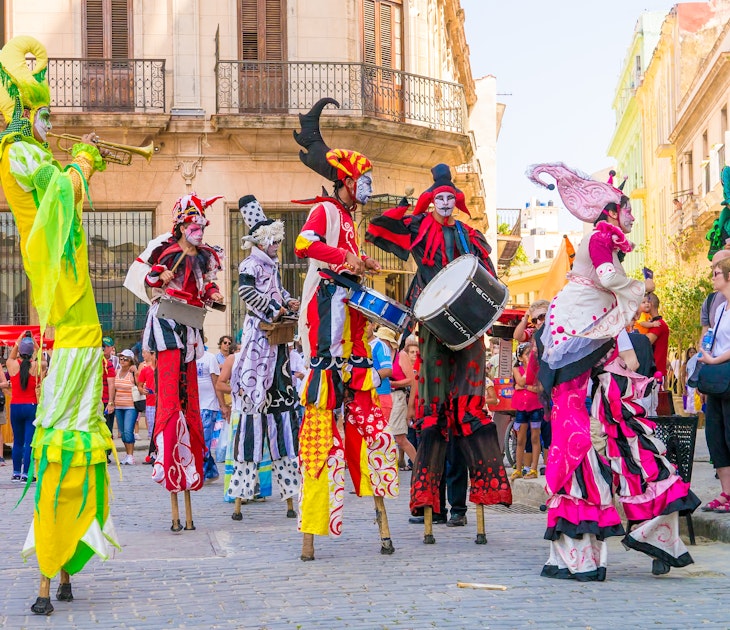 HAVANA, CUBA - APRIL 15,2015 : Colorful stiltwalkers dancing to the sound of cuban music in Old Havana.
