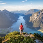 Mountaineer enjoying the view over lake Achensee in summer, Austria Tyrol