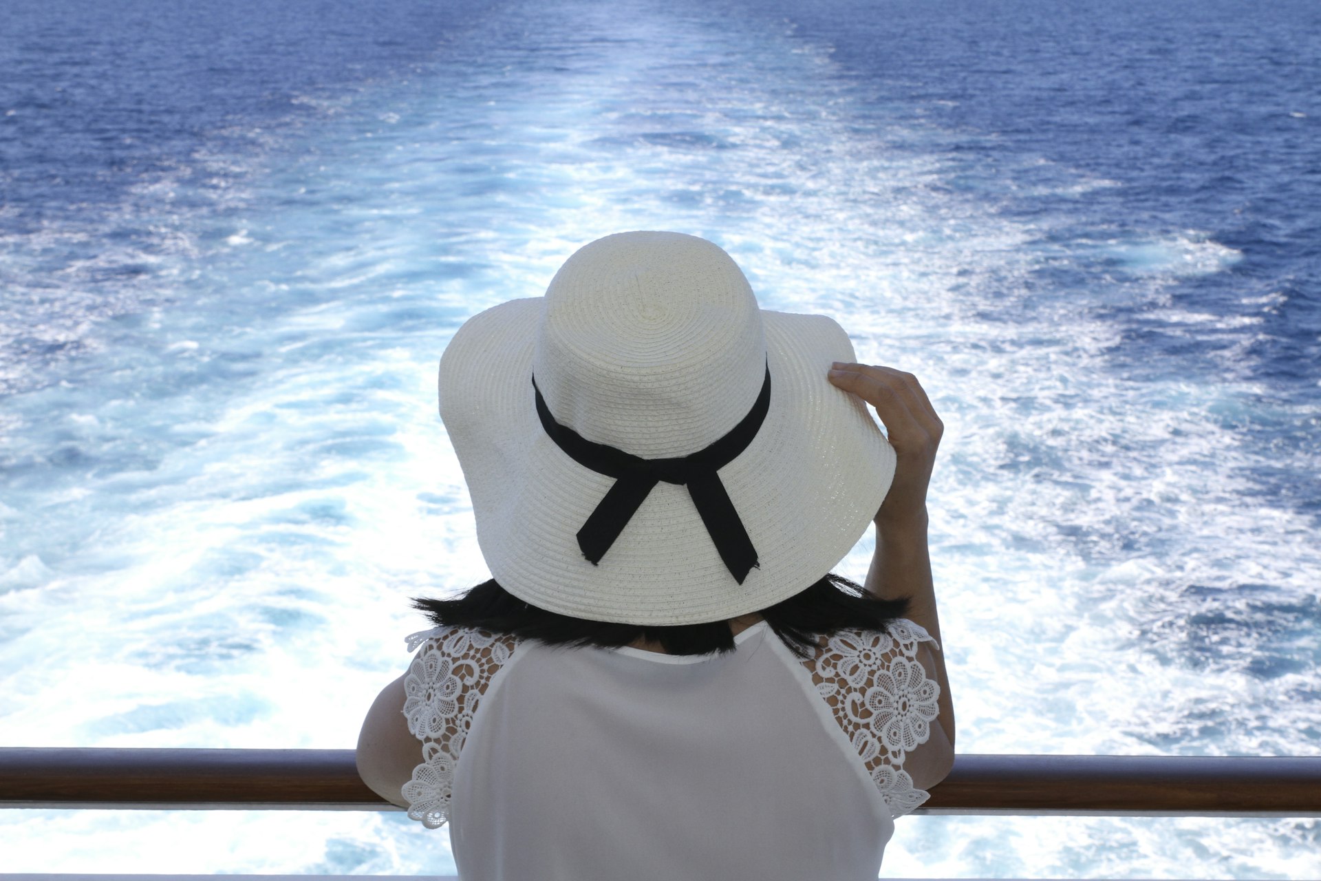 Woman looking out to sea on a cruise ship