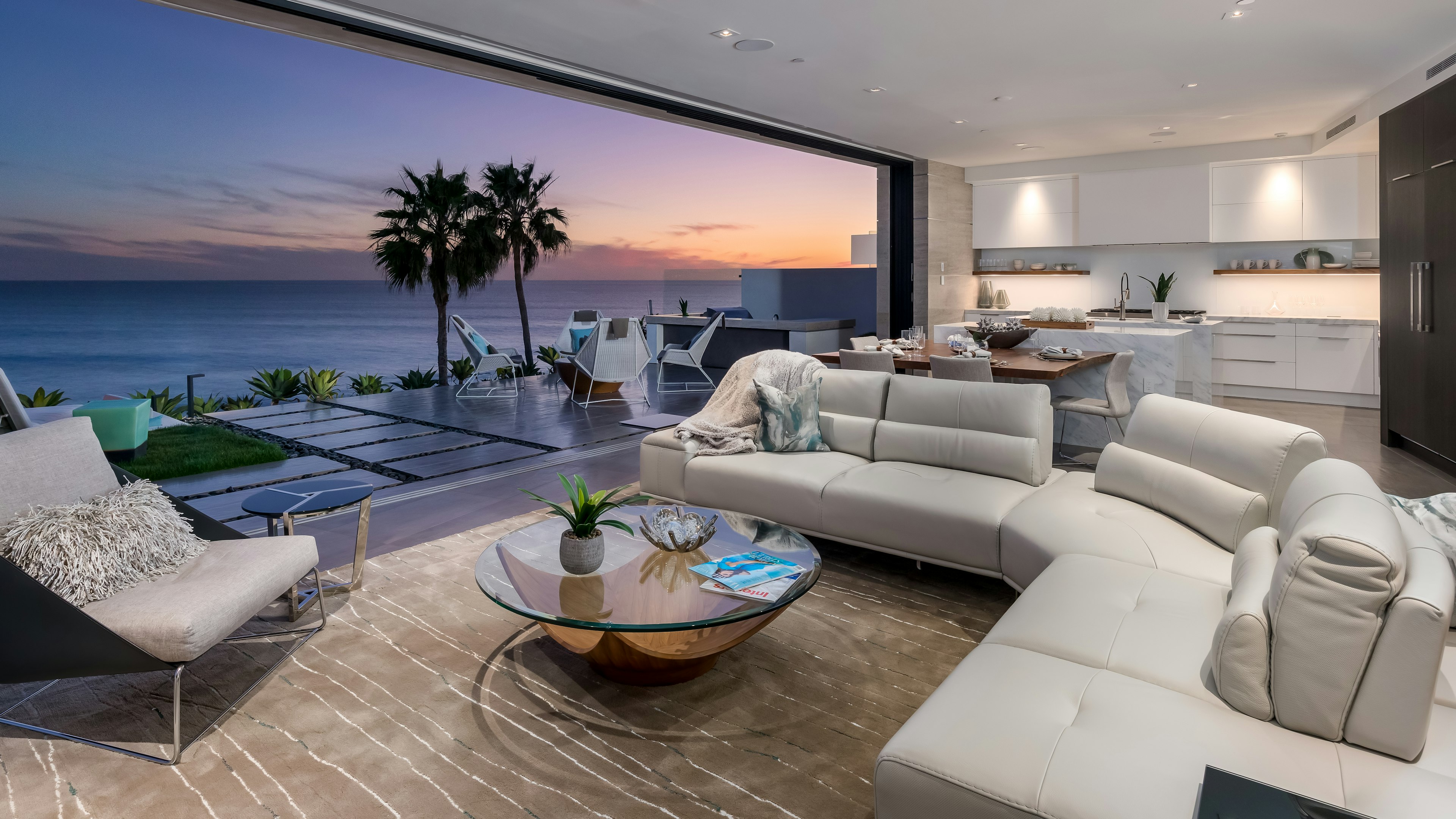 A luxe open living room with a view out to the water